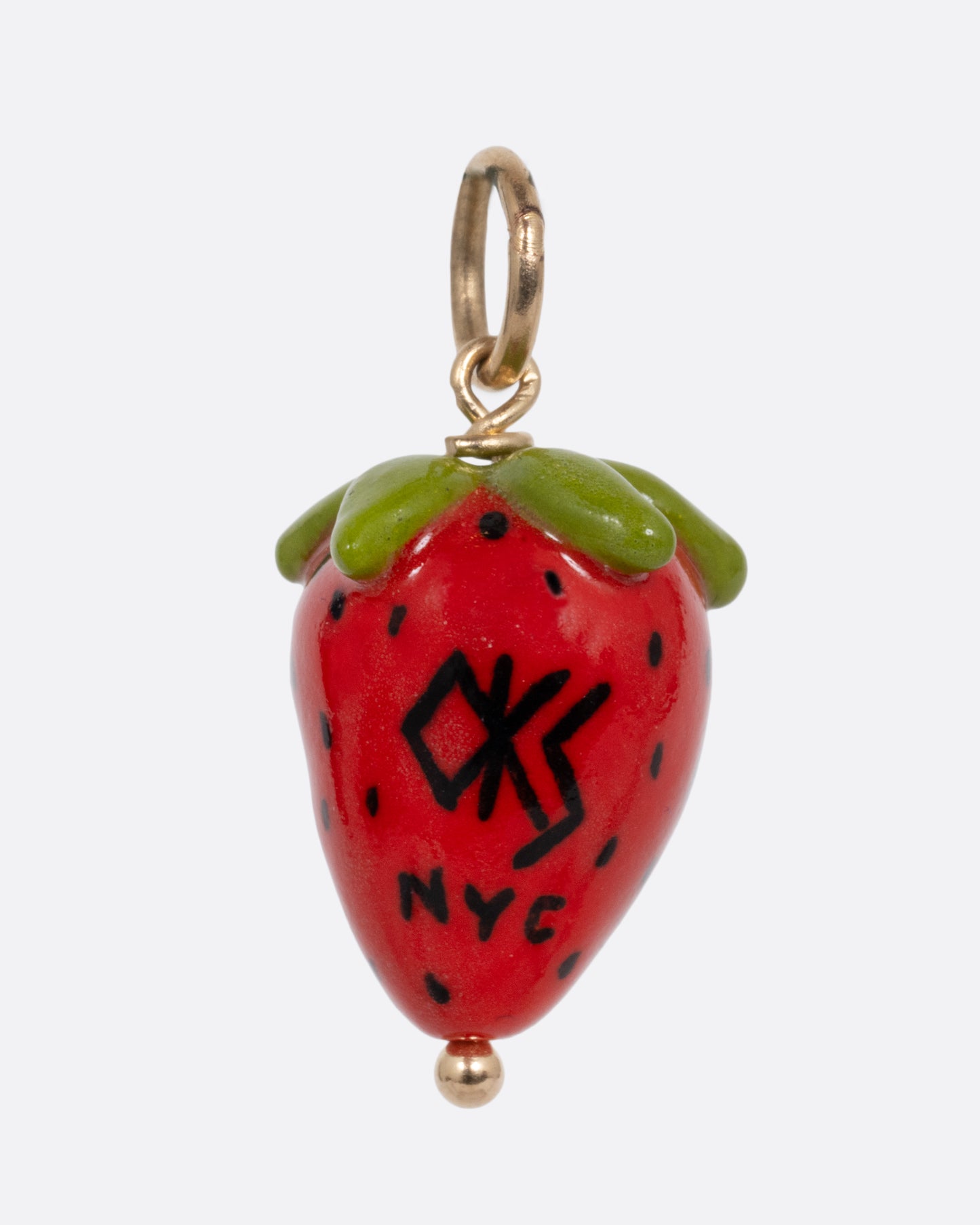 A red strawberry porcelain charm with a yellow gold bail. Shown from the back.