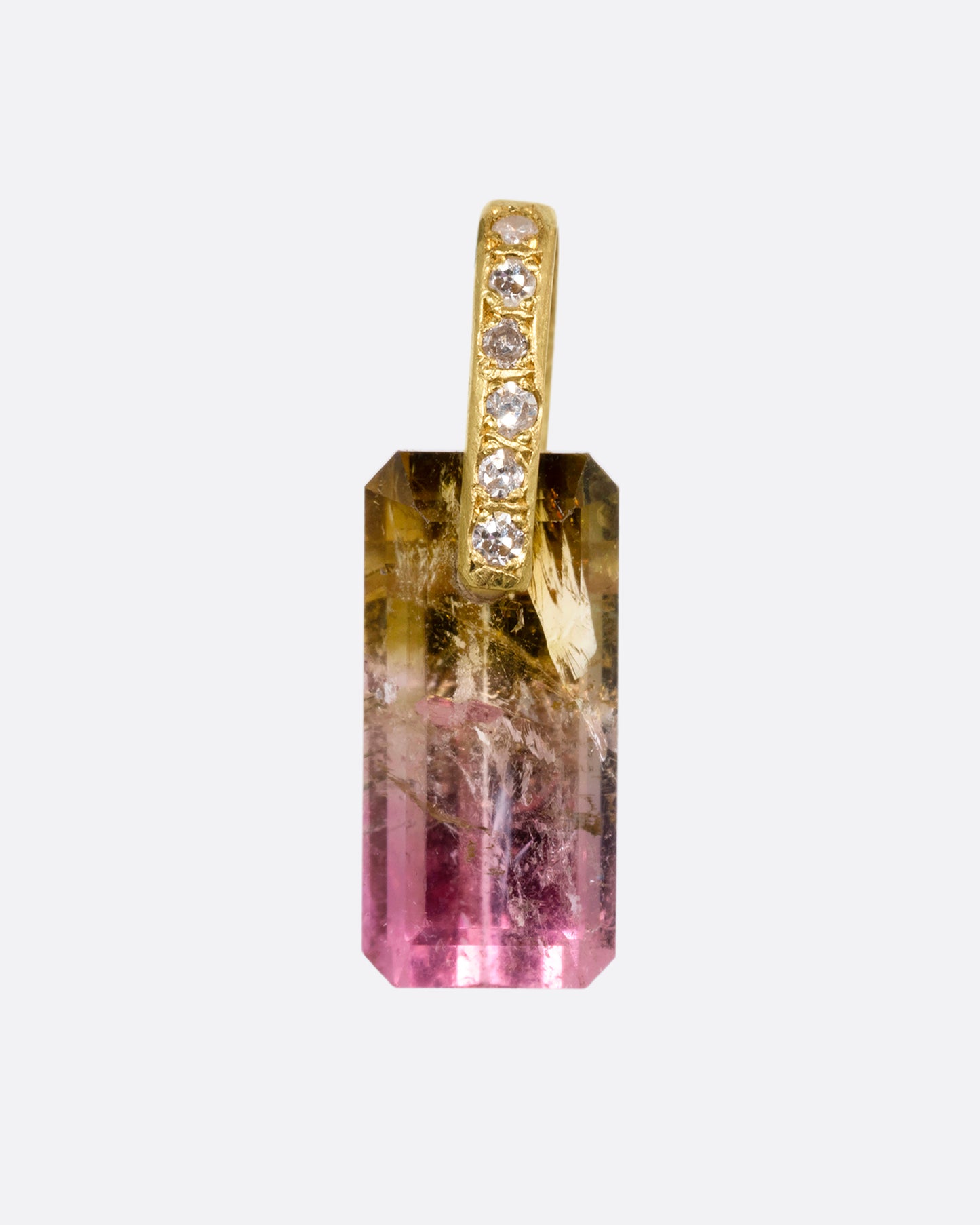 An emerald cut bicolor tourmaline charm with a yellow gold diamond lined bail. Shown from the front.