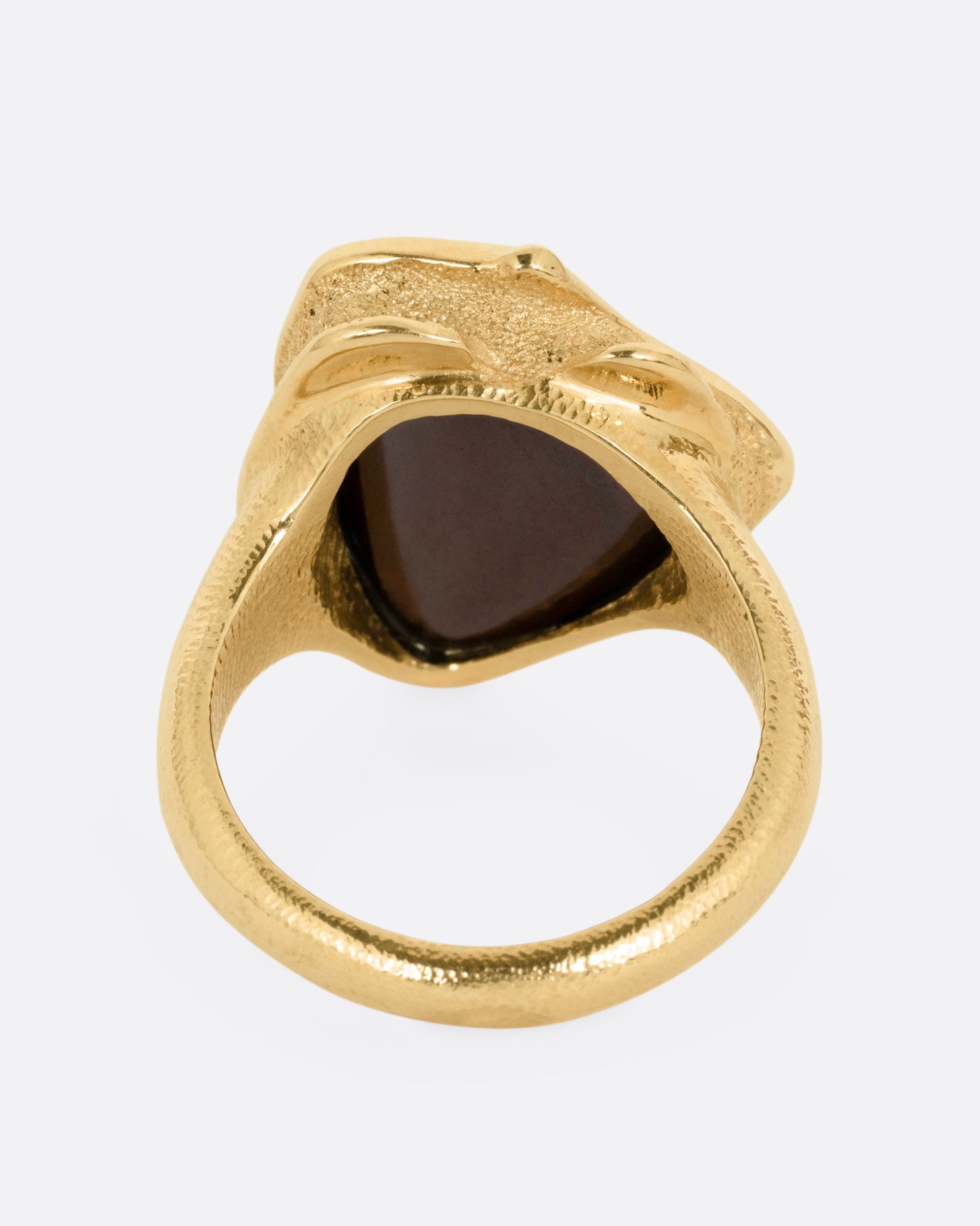 A yellow gold ring with a large boulder opal, shown from the back.