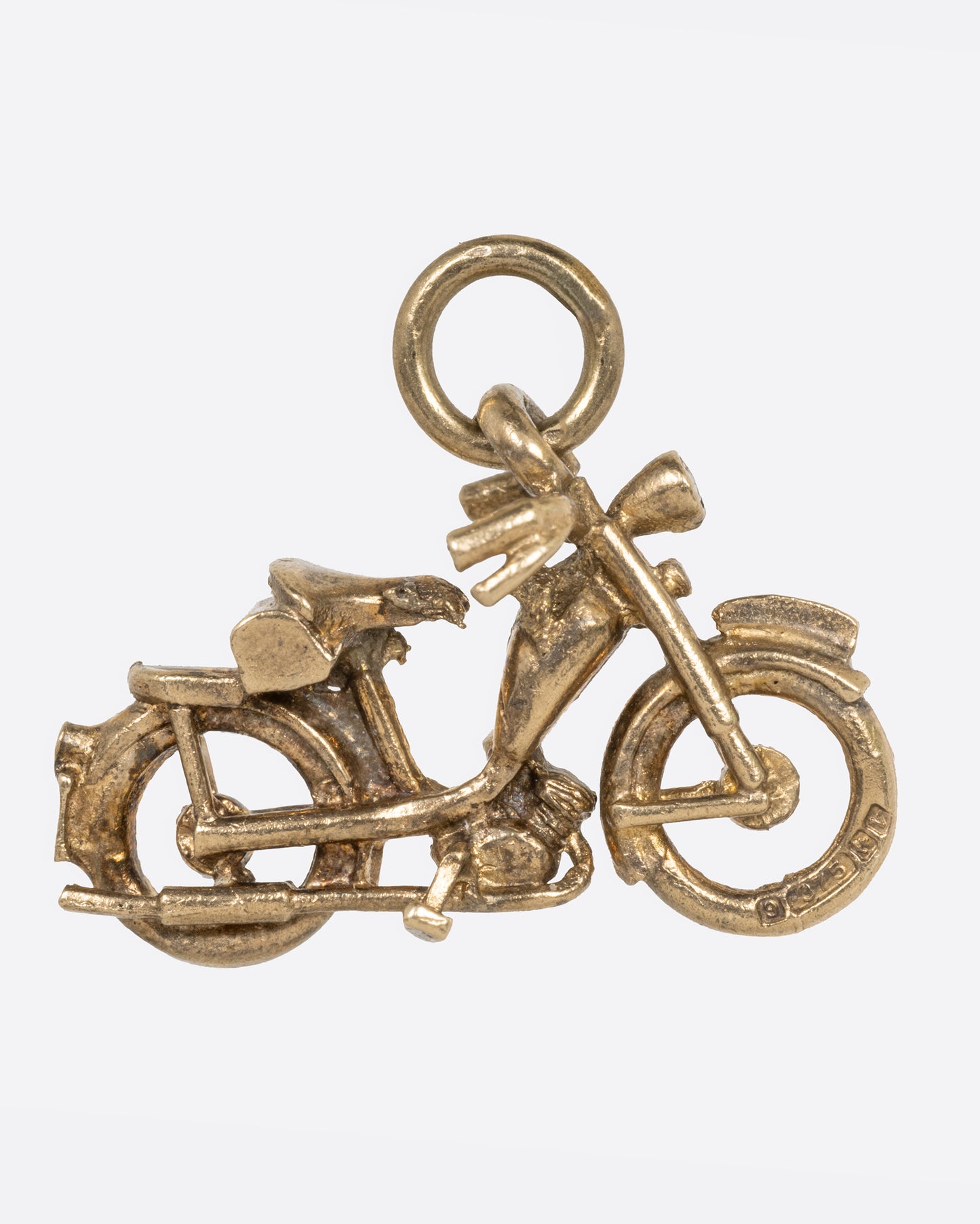 A yellow gold motorcycle charm, shown from the side.