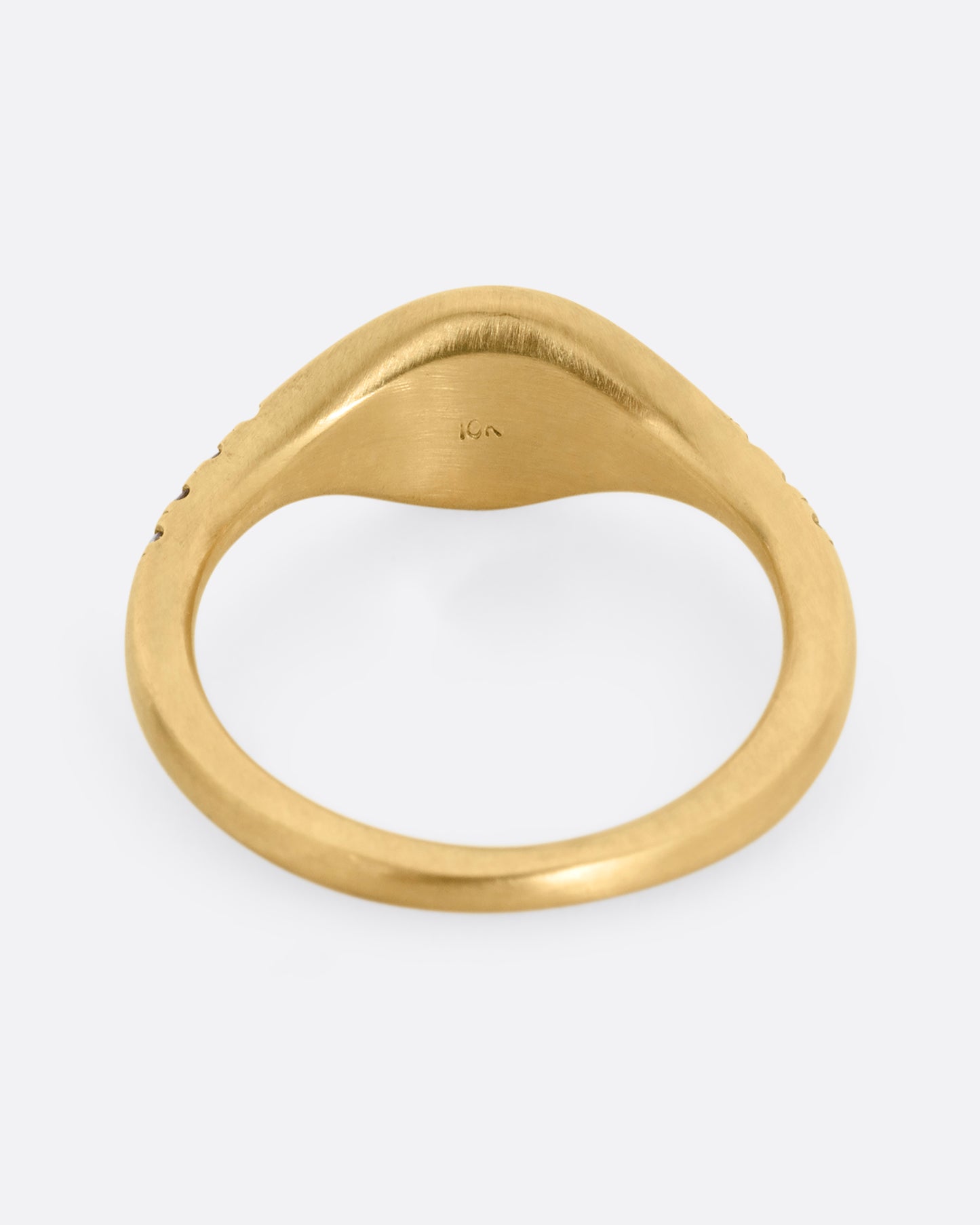 A yellow gold signet ring with diamonds on the shoulders. Shown from the back.