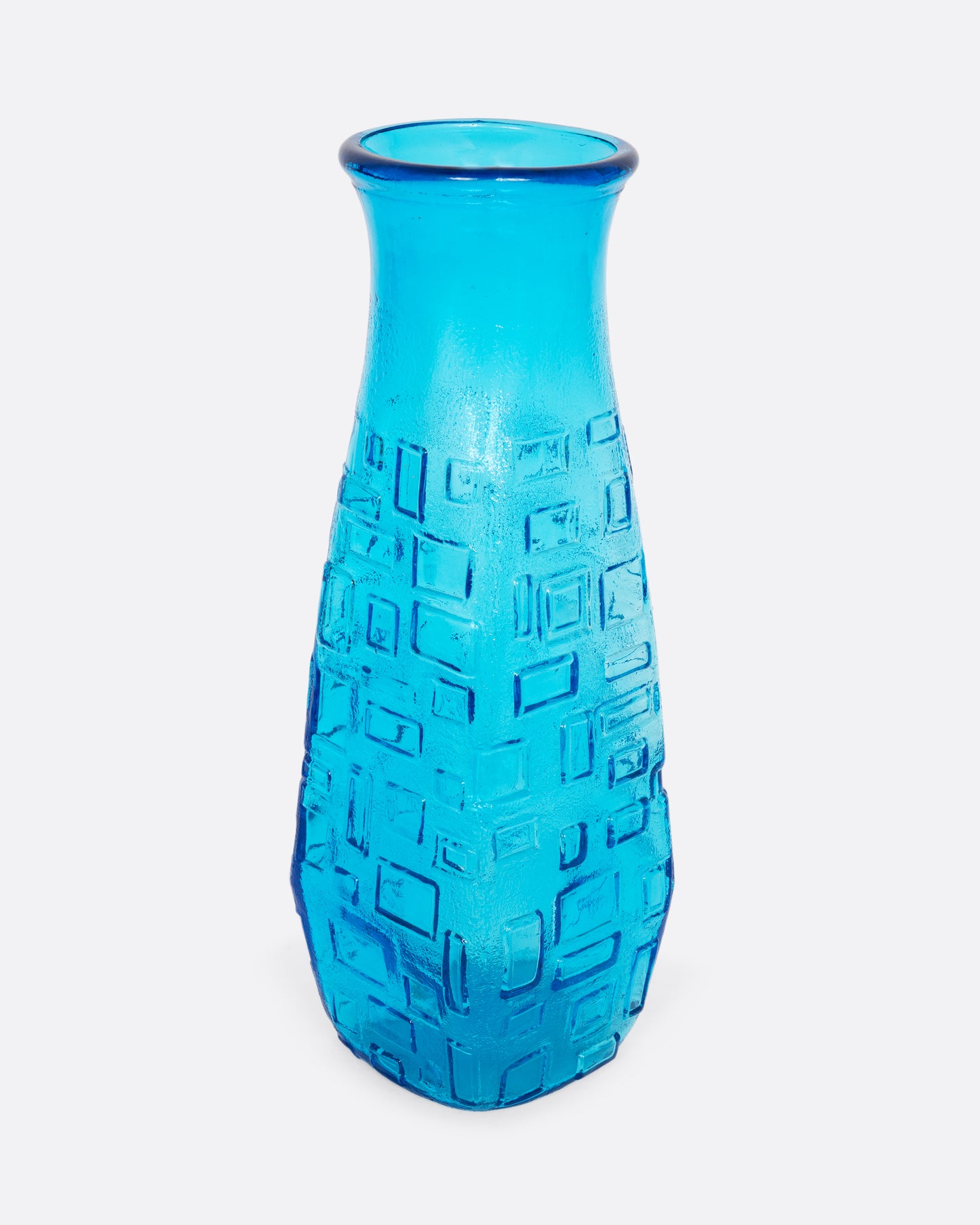 A tall cerulean glass vase with an all-over geometric pattern. Shown from the front.