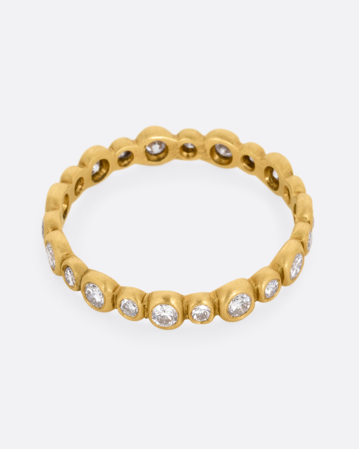 A yellow gold ring with a bubbly pattern of diamonds. Shown from the front.