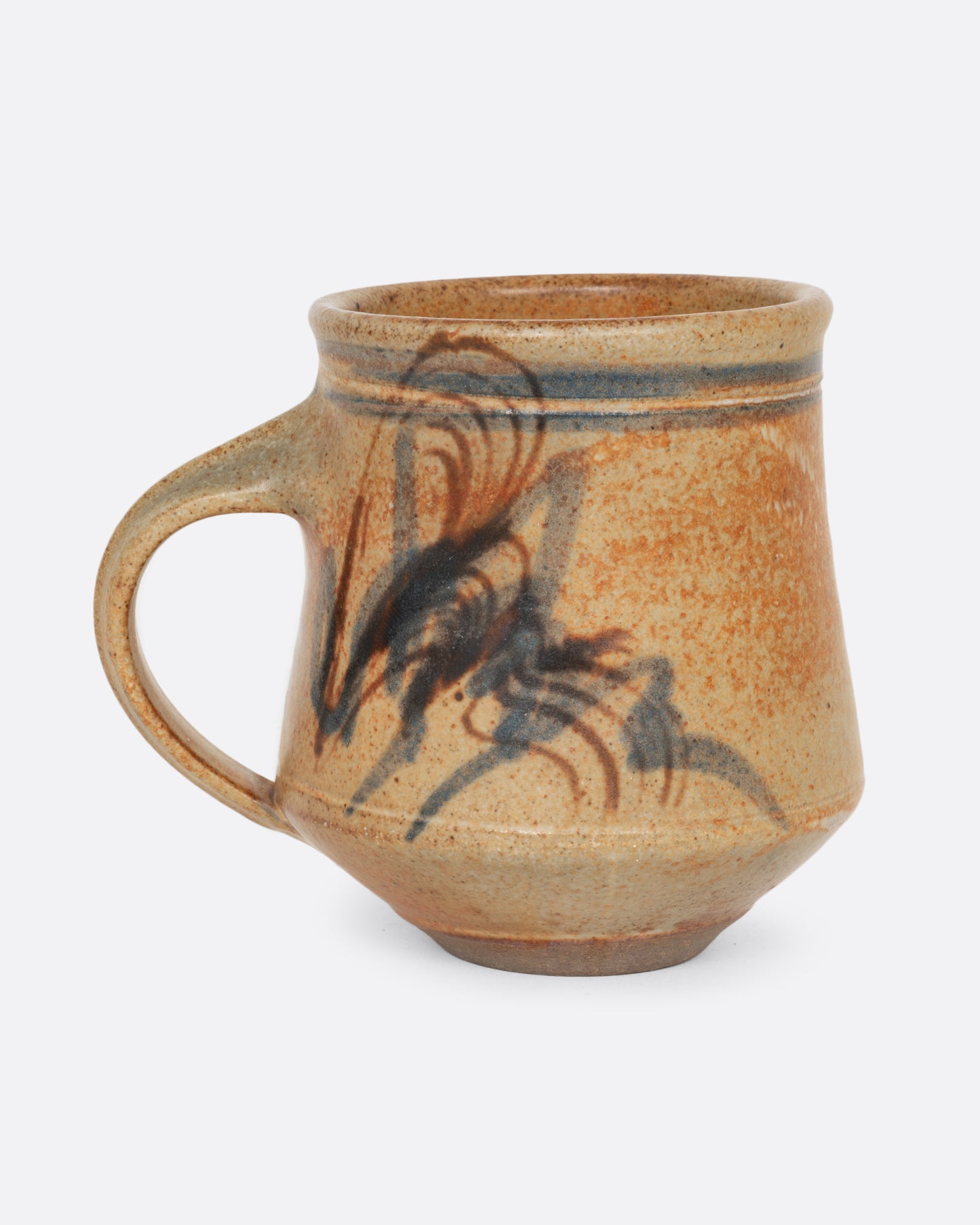A handmade ceramic mug with blue and brown brushstrokes. Shown from the side.