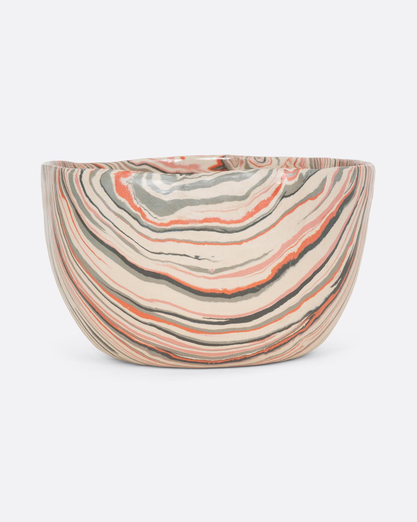 A ceramic bowl with peach, gray, and cream swirls. Shown from the front.