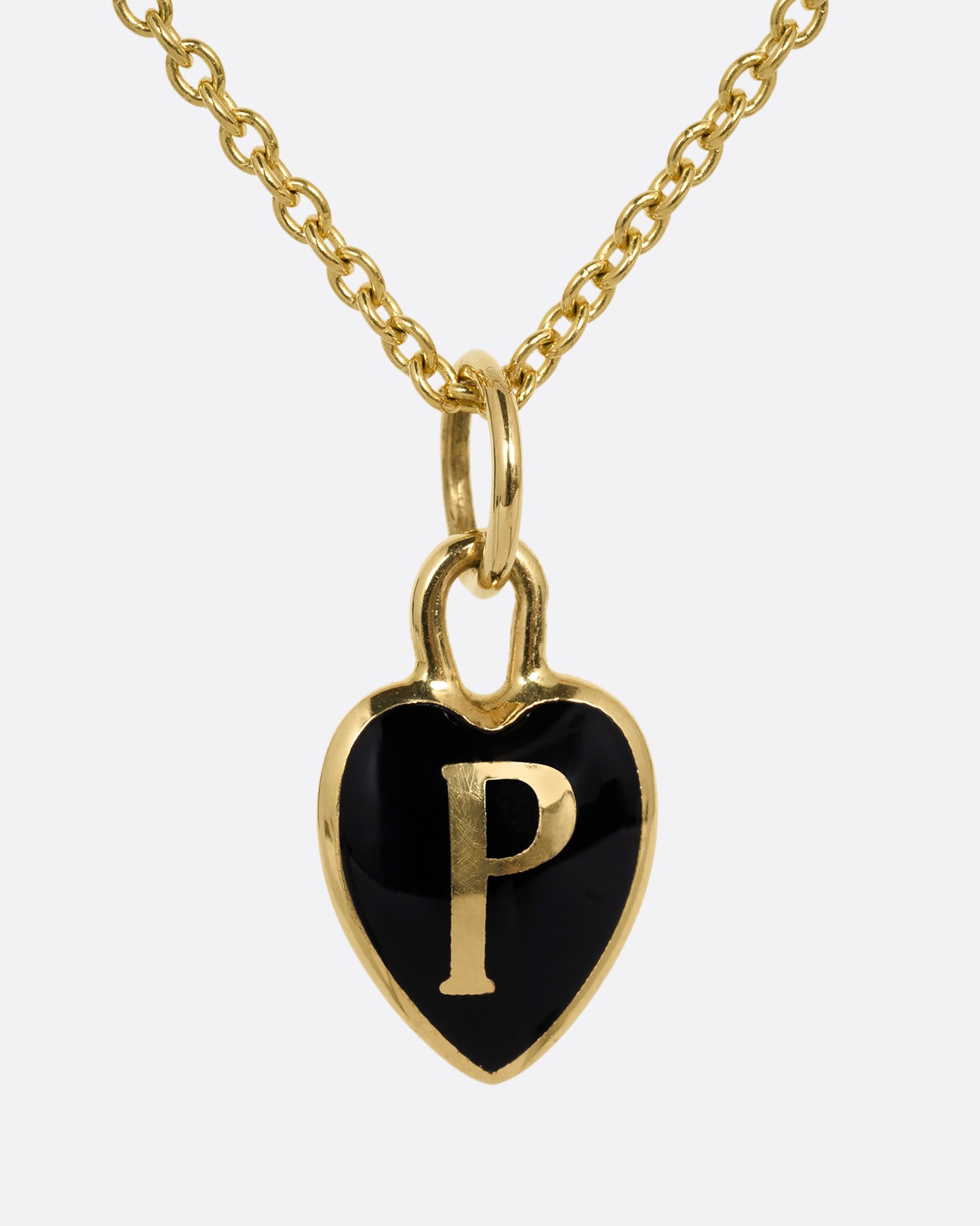 A yellow gold cable chain necklace with a black enamel 'P' heart pendant. Shown from the front.