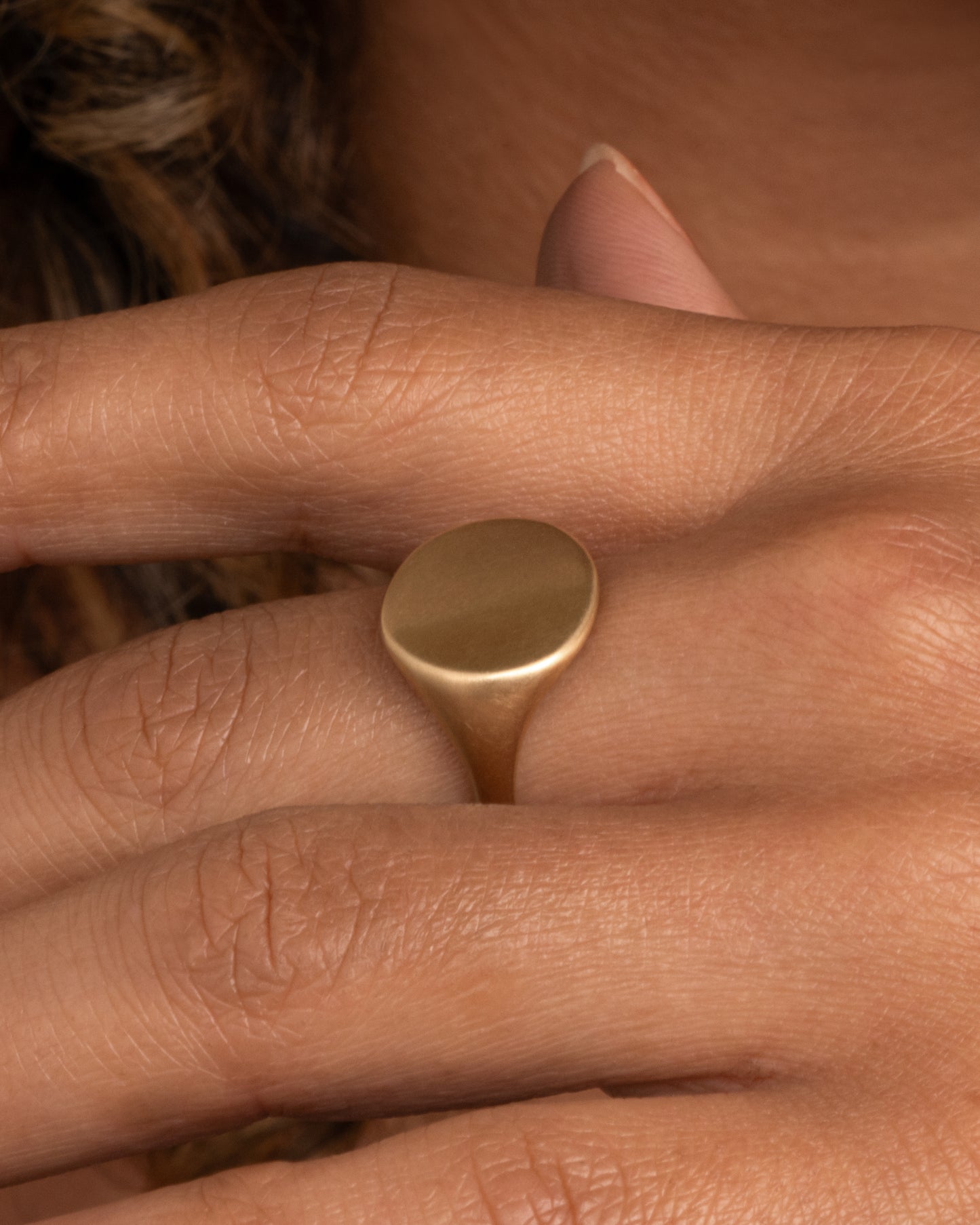 This solid 14k gold oval signet ring is incredibly soft and comfortable. The band is perfectly weighted, so the signet never falls to the side. Shown worn on hand.