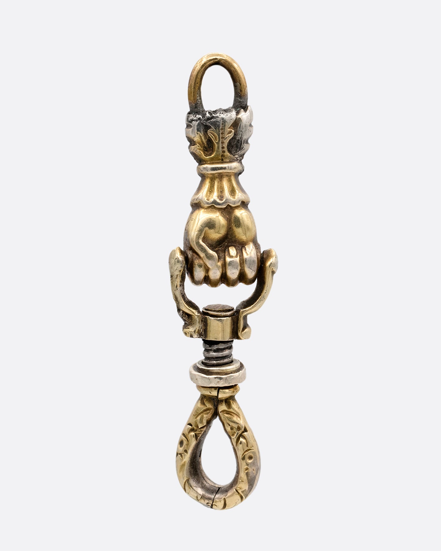 A yellow gold charm holder with a 'knocker' style hand in a fist between each looped end. shown from the back.