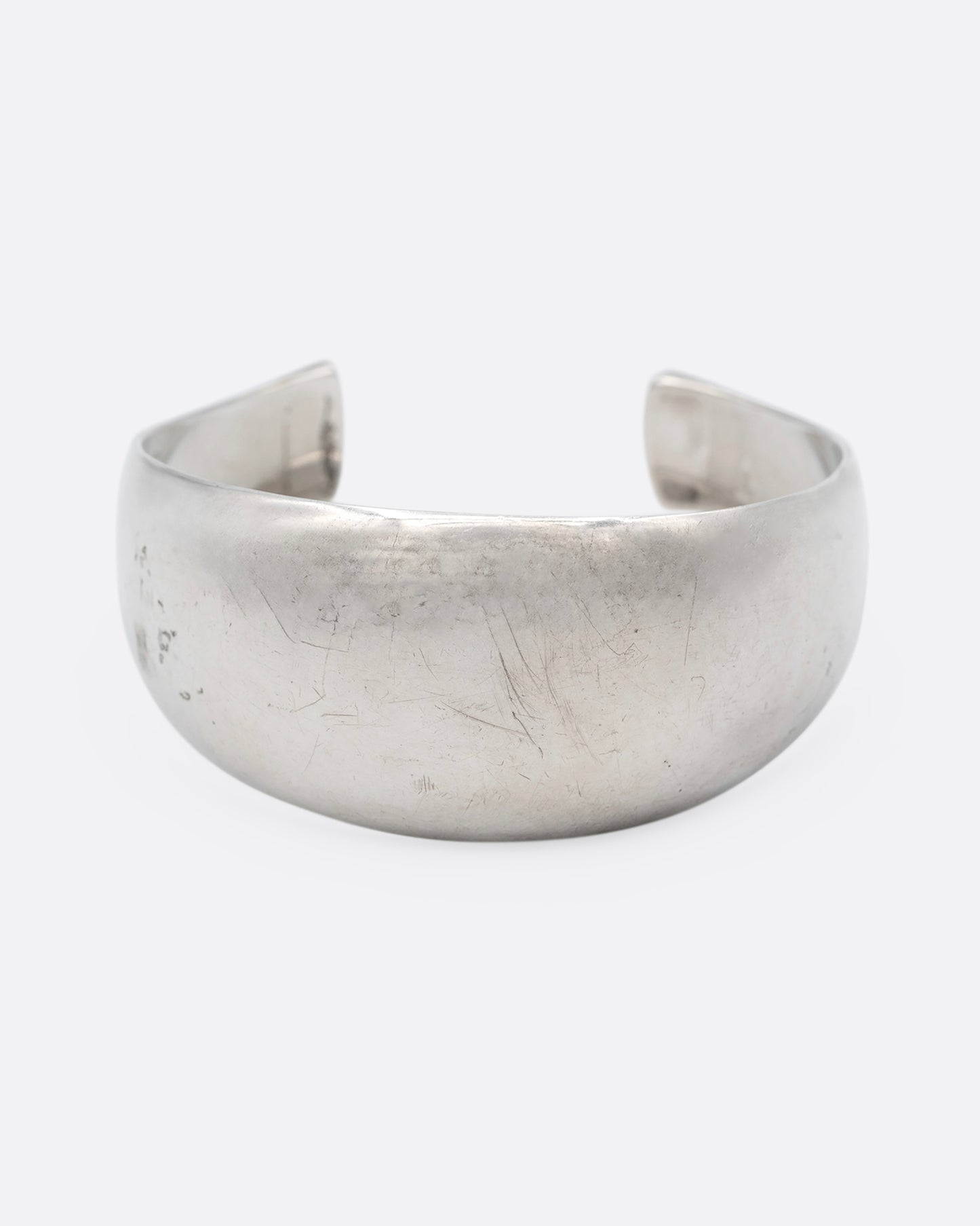 A silver cuff bracelet with smooth edges, shown from the front.