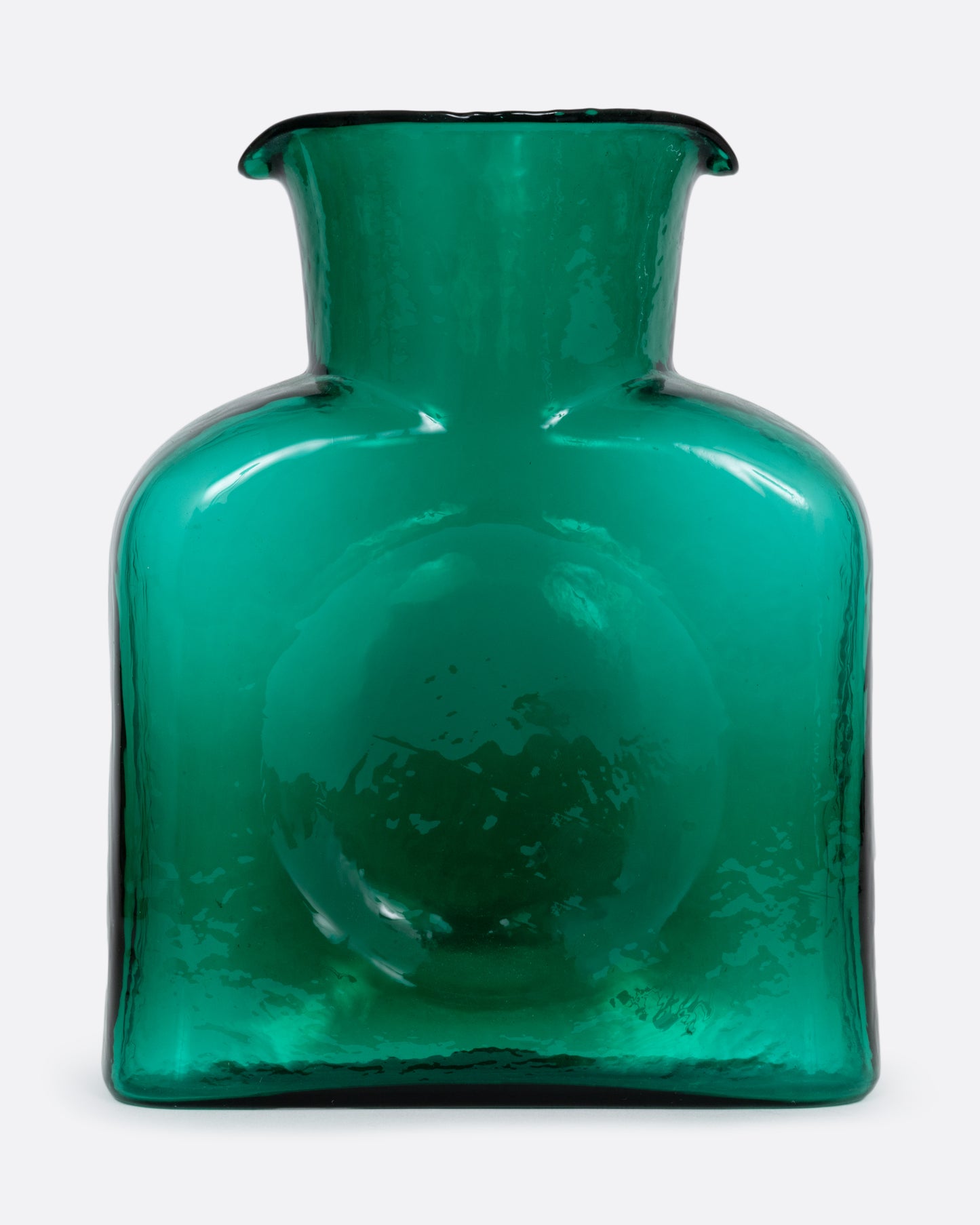 A green glass double spouted 'water bottle' from Blenko. Shown from the front.