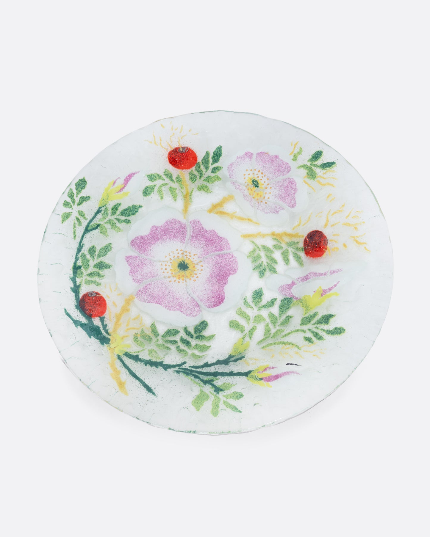 A clear fused glass plate with a floral motif. Shown from the top.