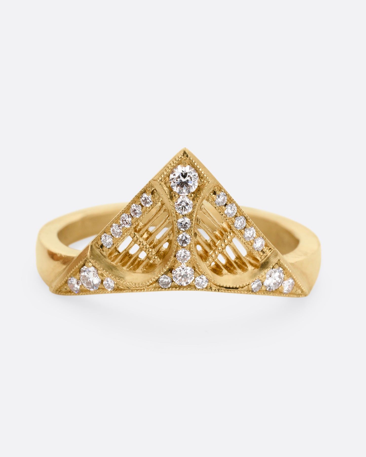 A yellow gold ring with a triangular face, white diamond accents, and cutouts. Shown from the front.