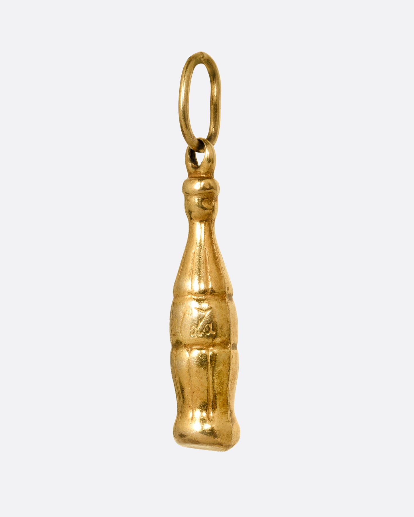 A yellow gold Coca-Cola bottle charm shown from the side.