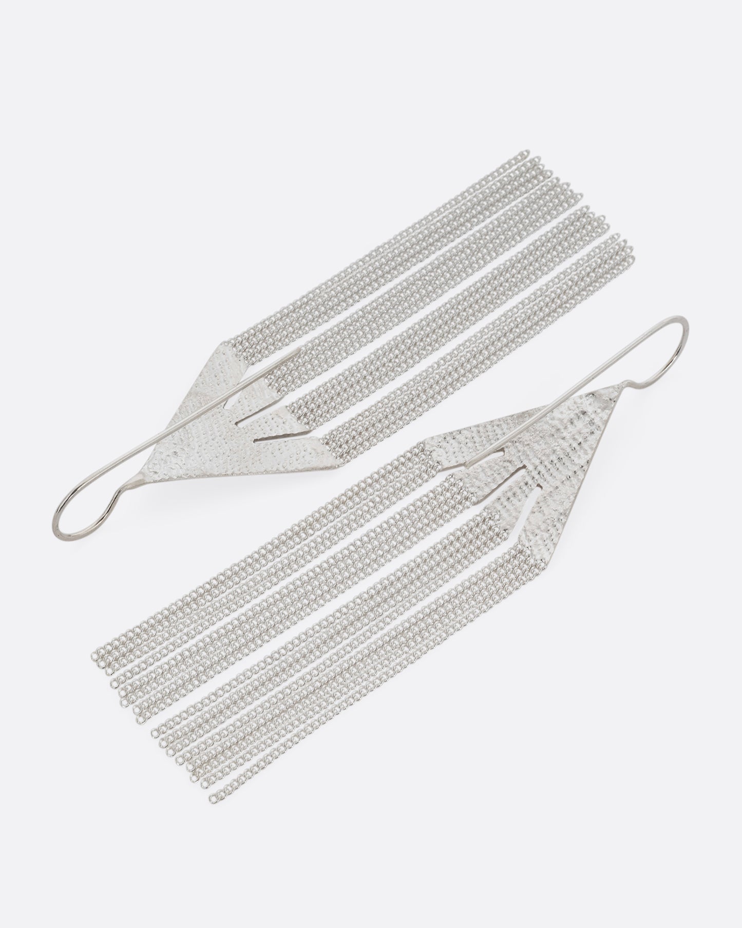 A pair of silver fringe earrings with triangular tops. Shown from the back.