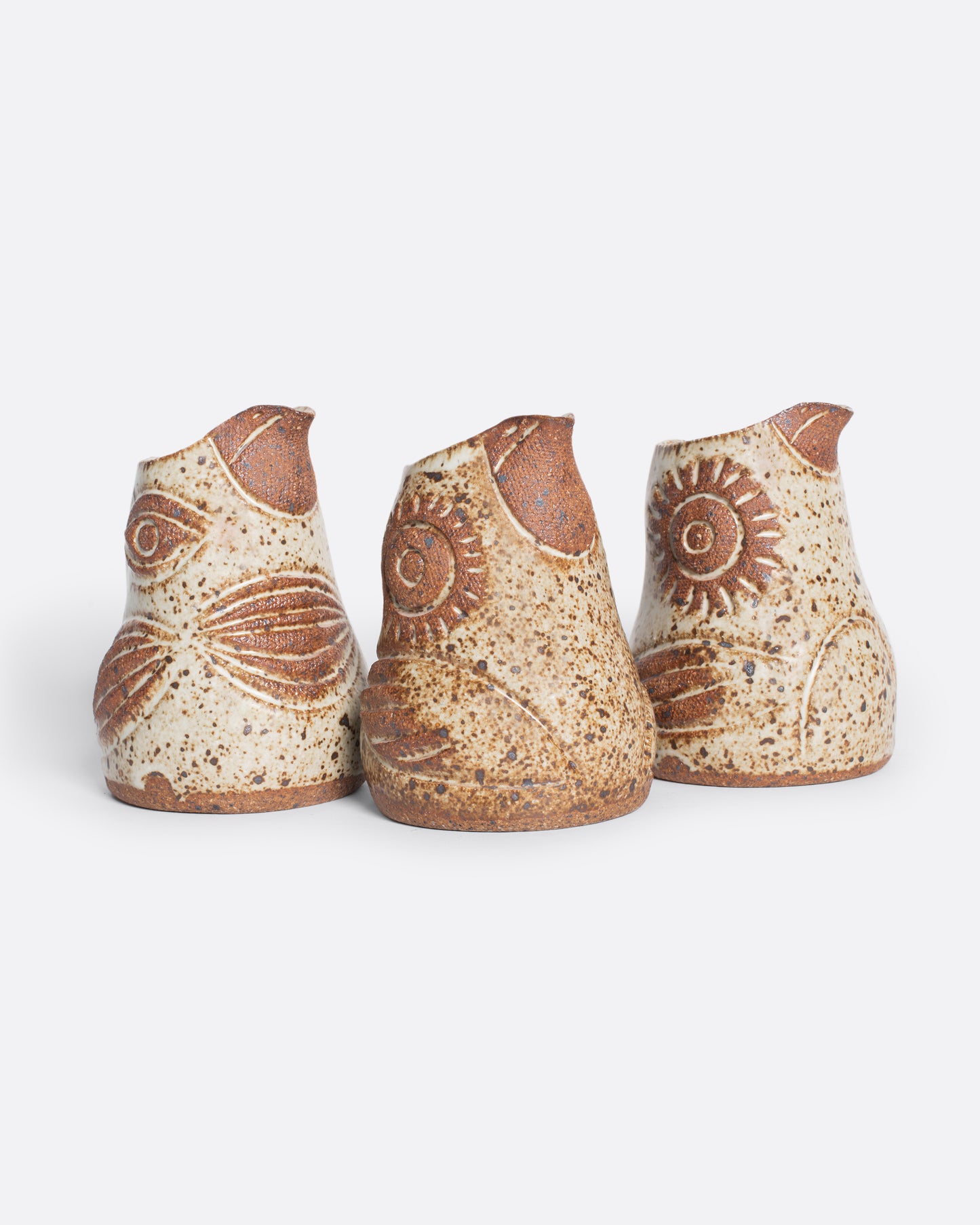 A handmade ceramic bird creamer, full of personality, with an impressionist design and speckled, satin glaze.