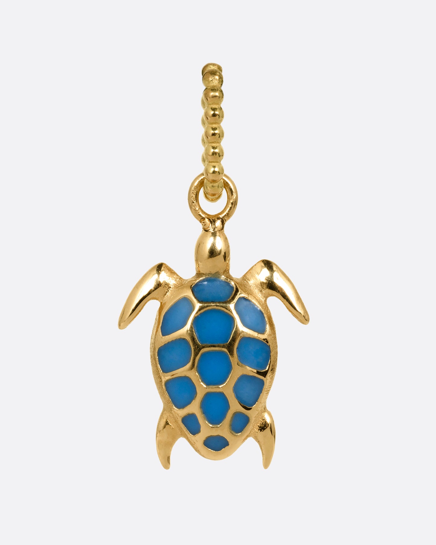 A yellow gold and neon blue enamel miniature sea turtle charm. Shown from the front.