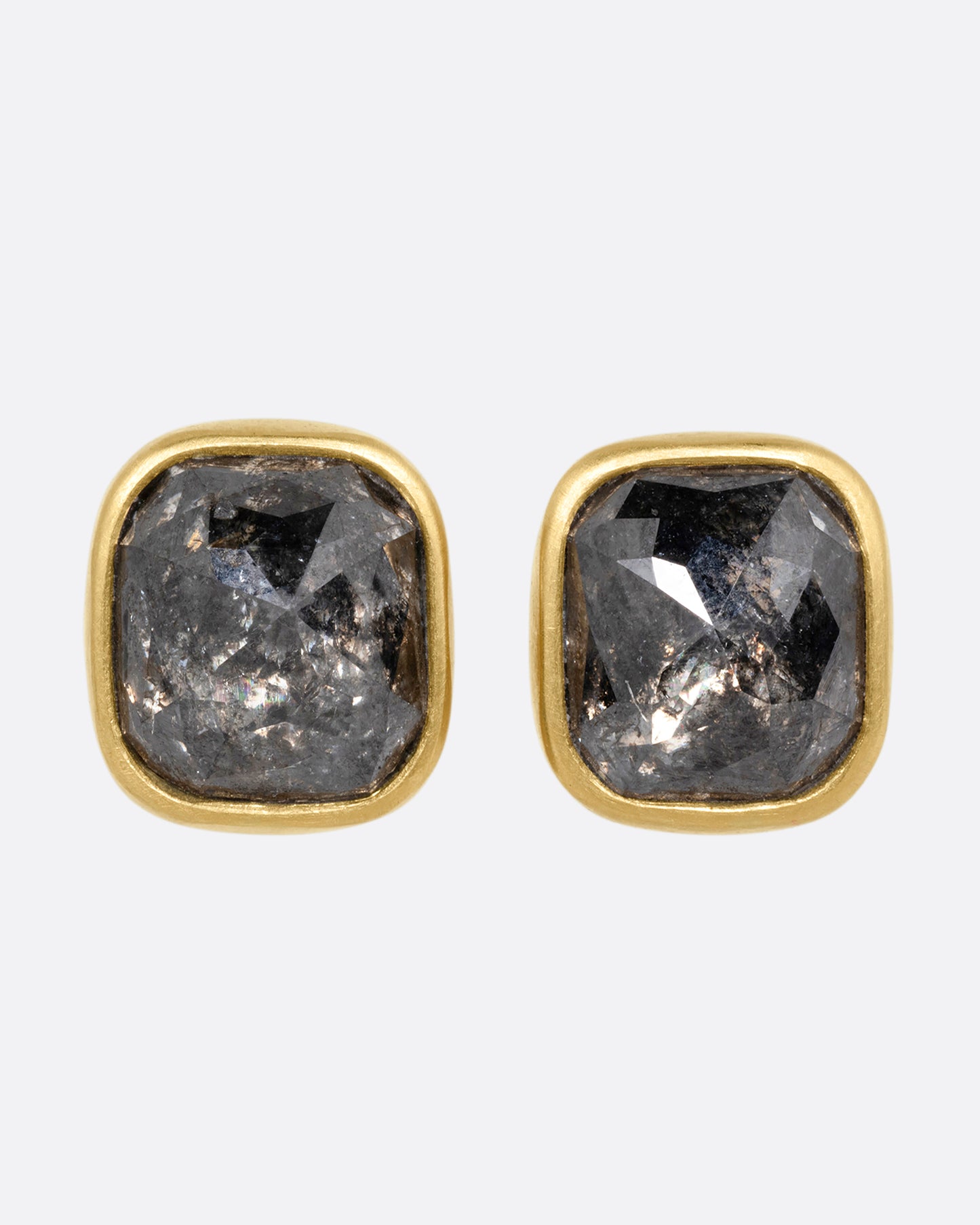 A pair of yellow gold square salt and pepper stud earrings, shown from the front.