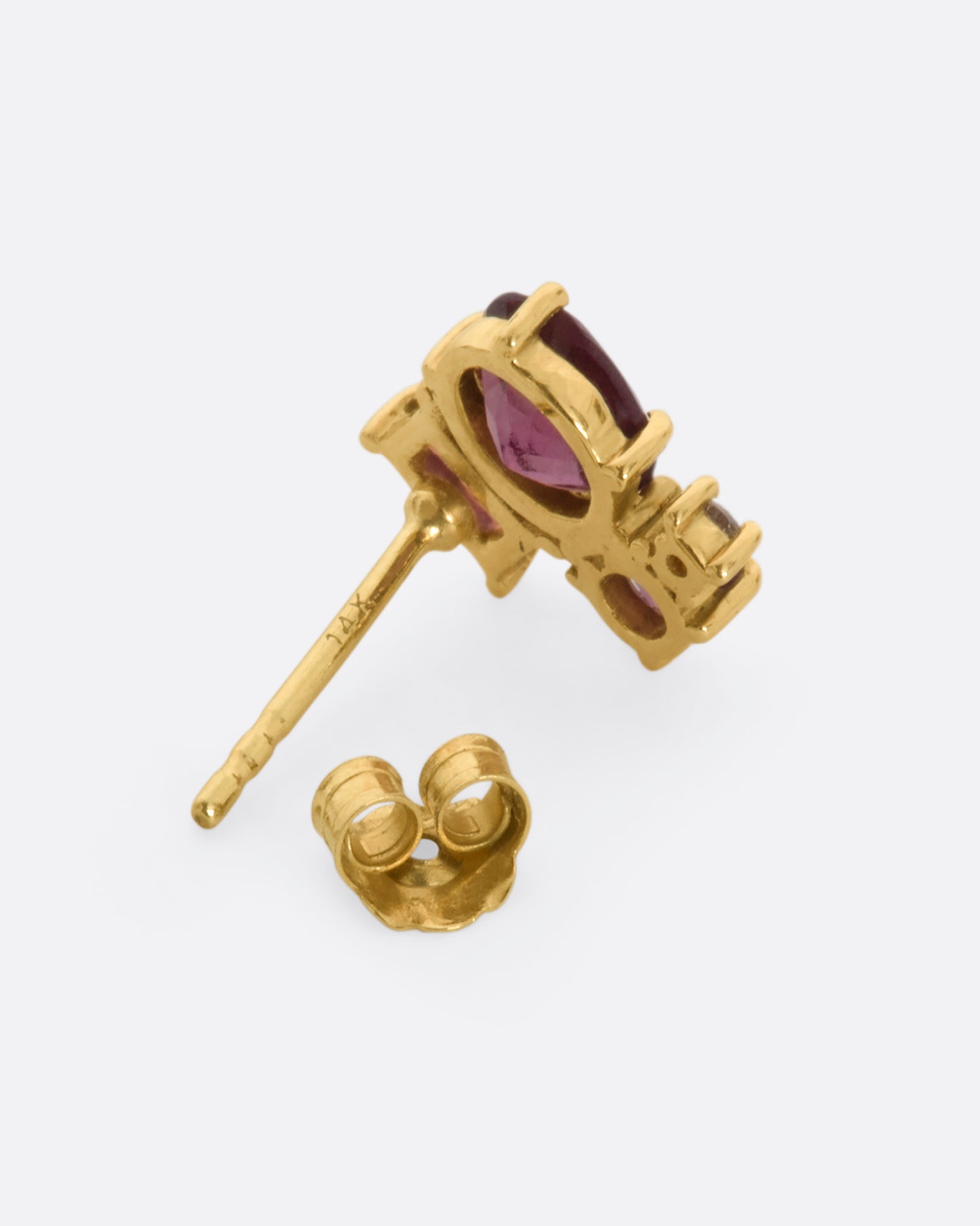 A yellow gold stud earring with a mosaic of prong set tourmalines. View from the back.
