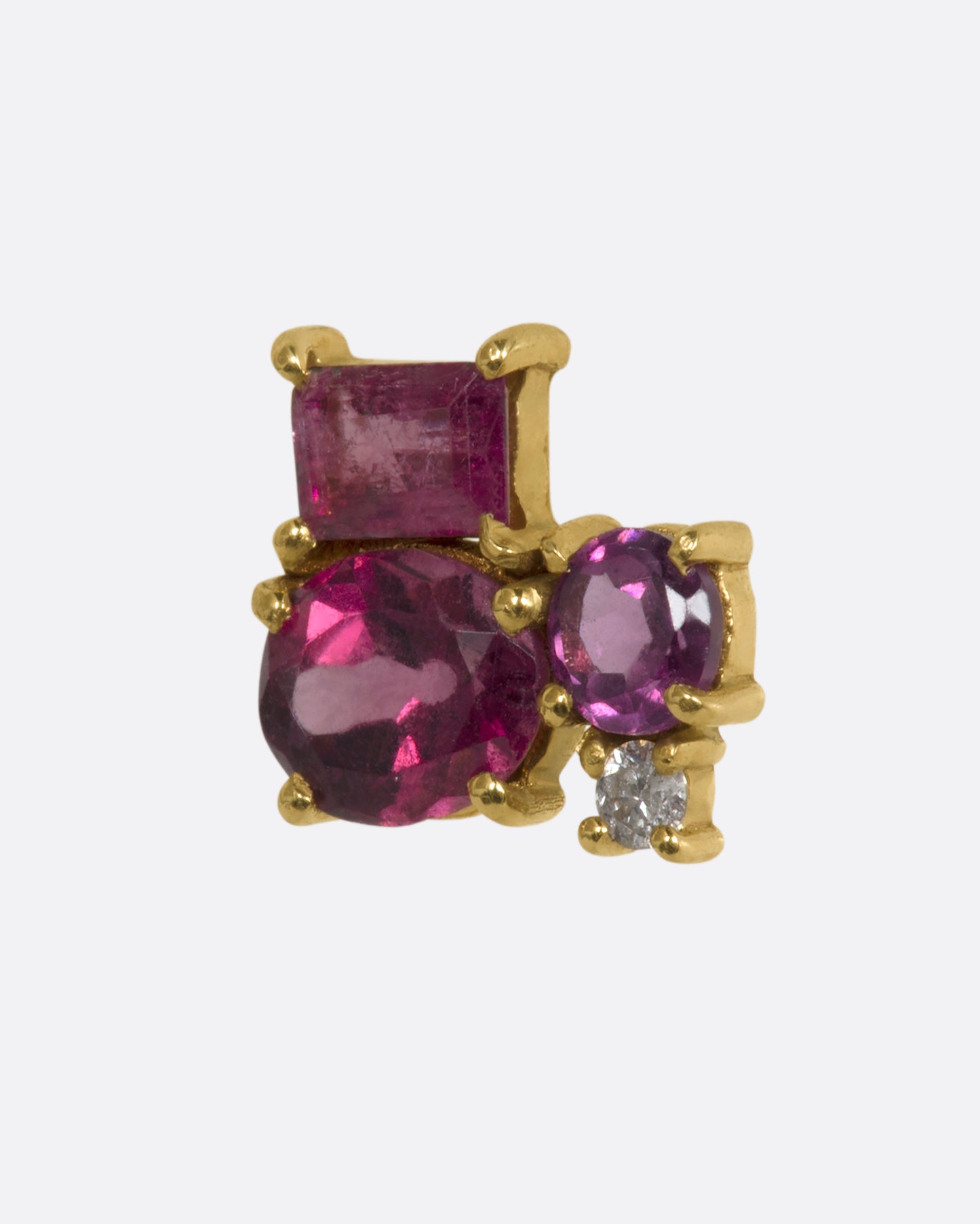 A yellow gold stud earring with a mosaic of prong set tourmalines. View from the side.