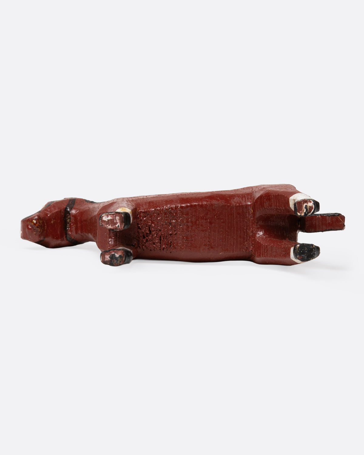 A hand painted and carved wooden bay horse, shown from the bottom.