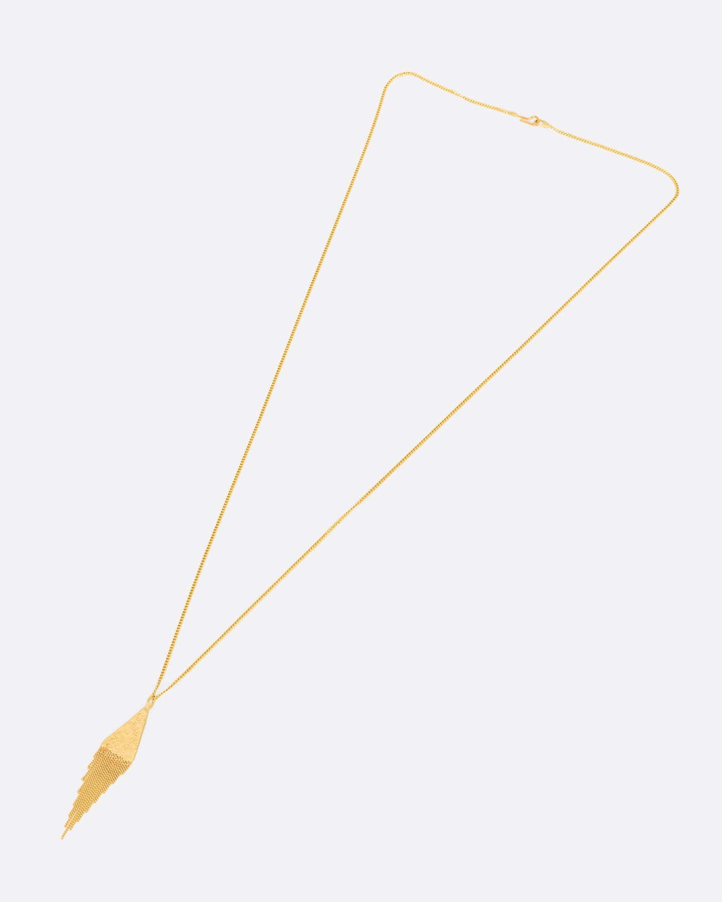 A yellow gold necklace with a fringed triangle pendant. View of the entire necklace laying flat.