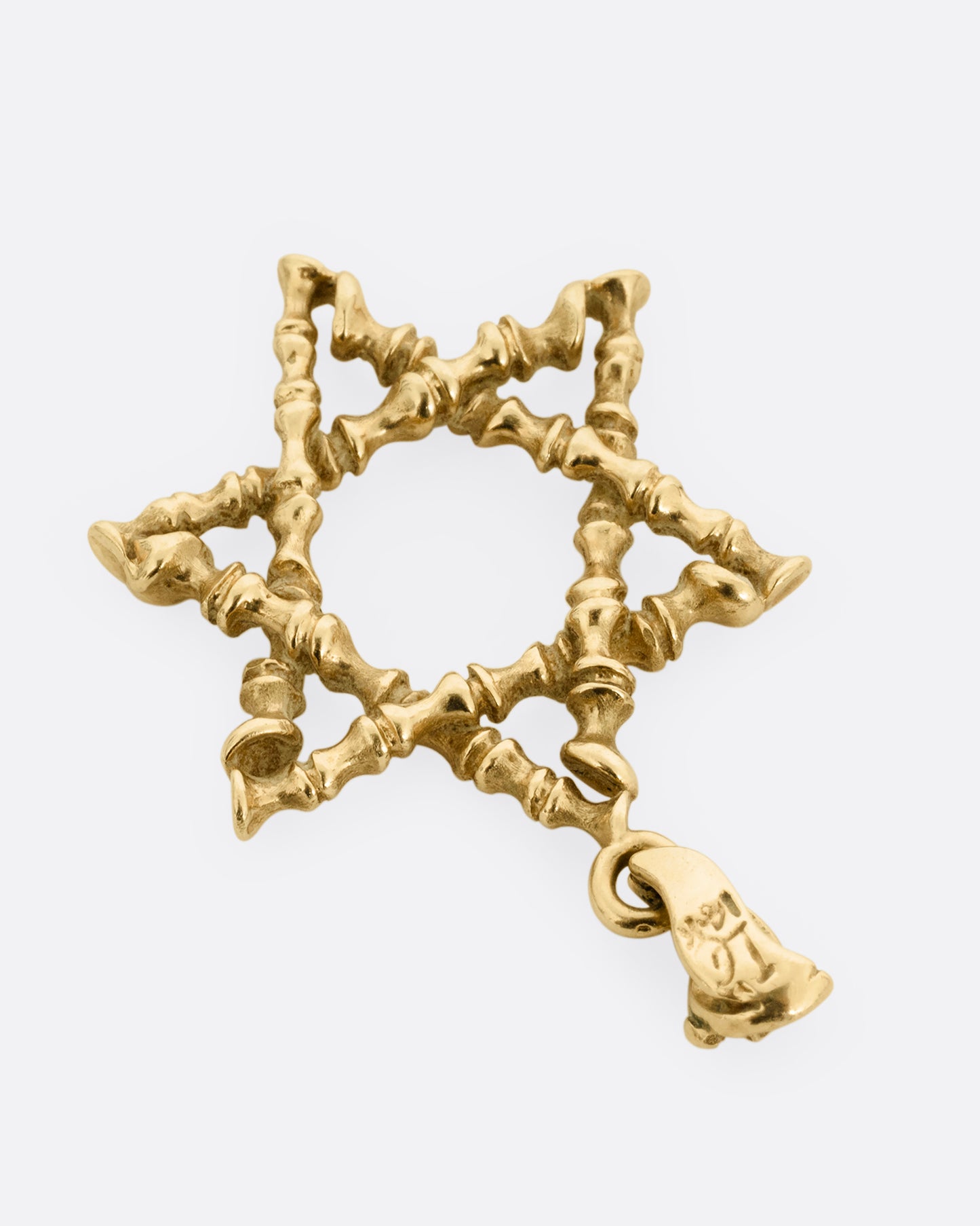 A yellow gold Star of David pendant with textural lines, shown from the back.