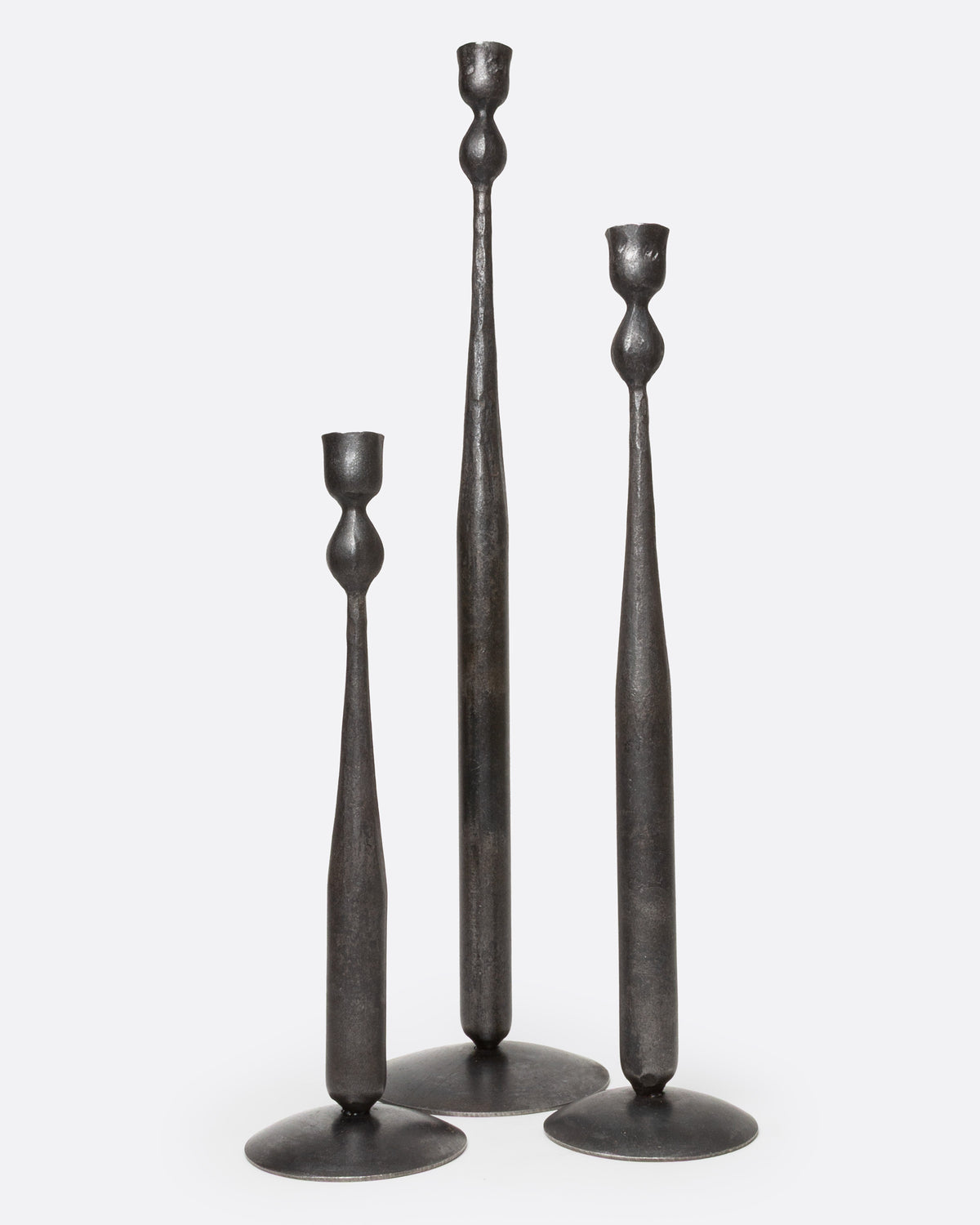 Black forged iron taper candle holder, shown with other heights
