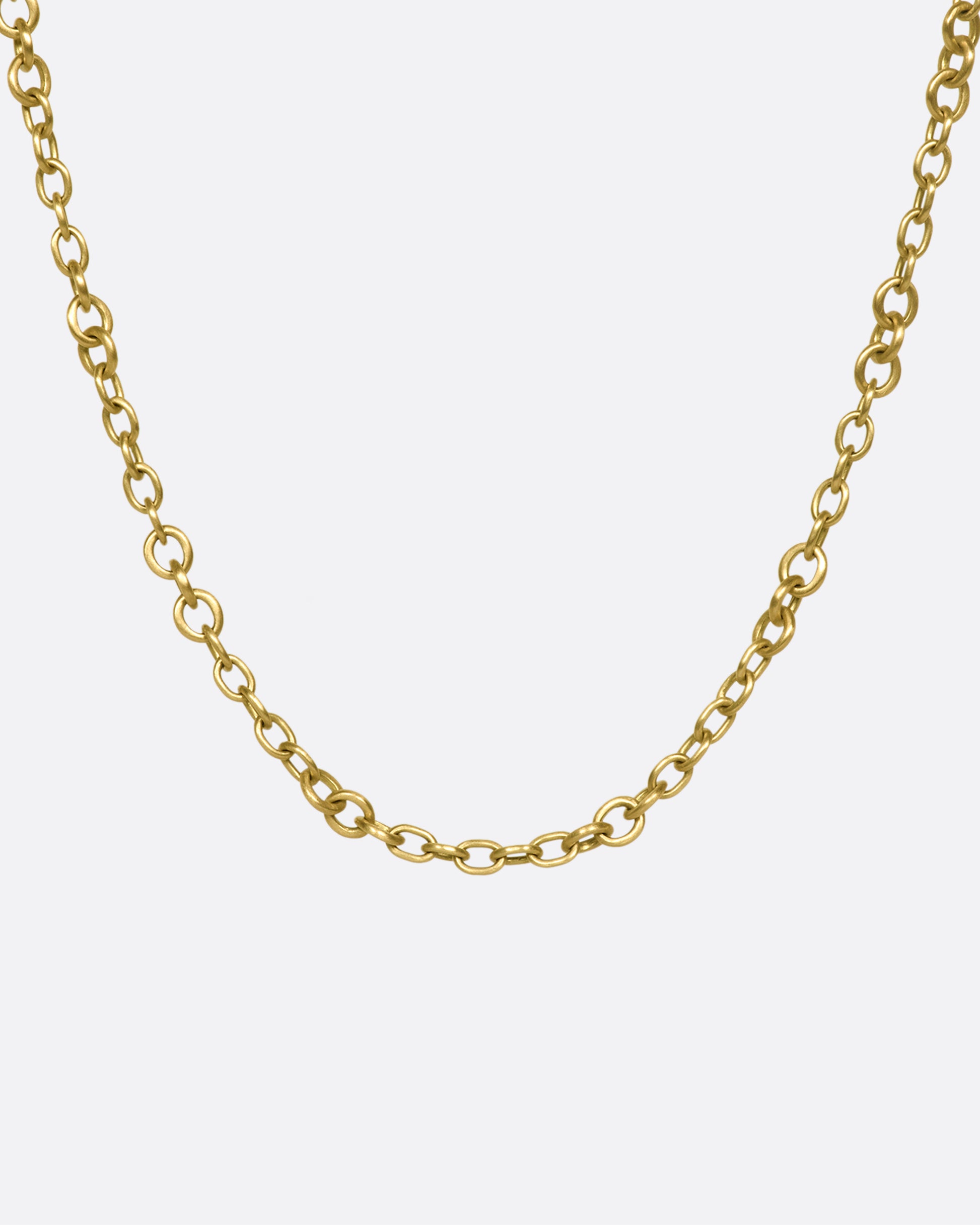A beautiful 18K gold chain that will rest along your collar bone. Heavy enough to wear on its own in a neck mess and fine enough to add a pendant or two.