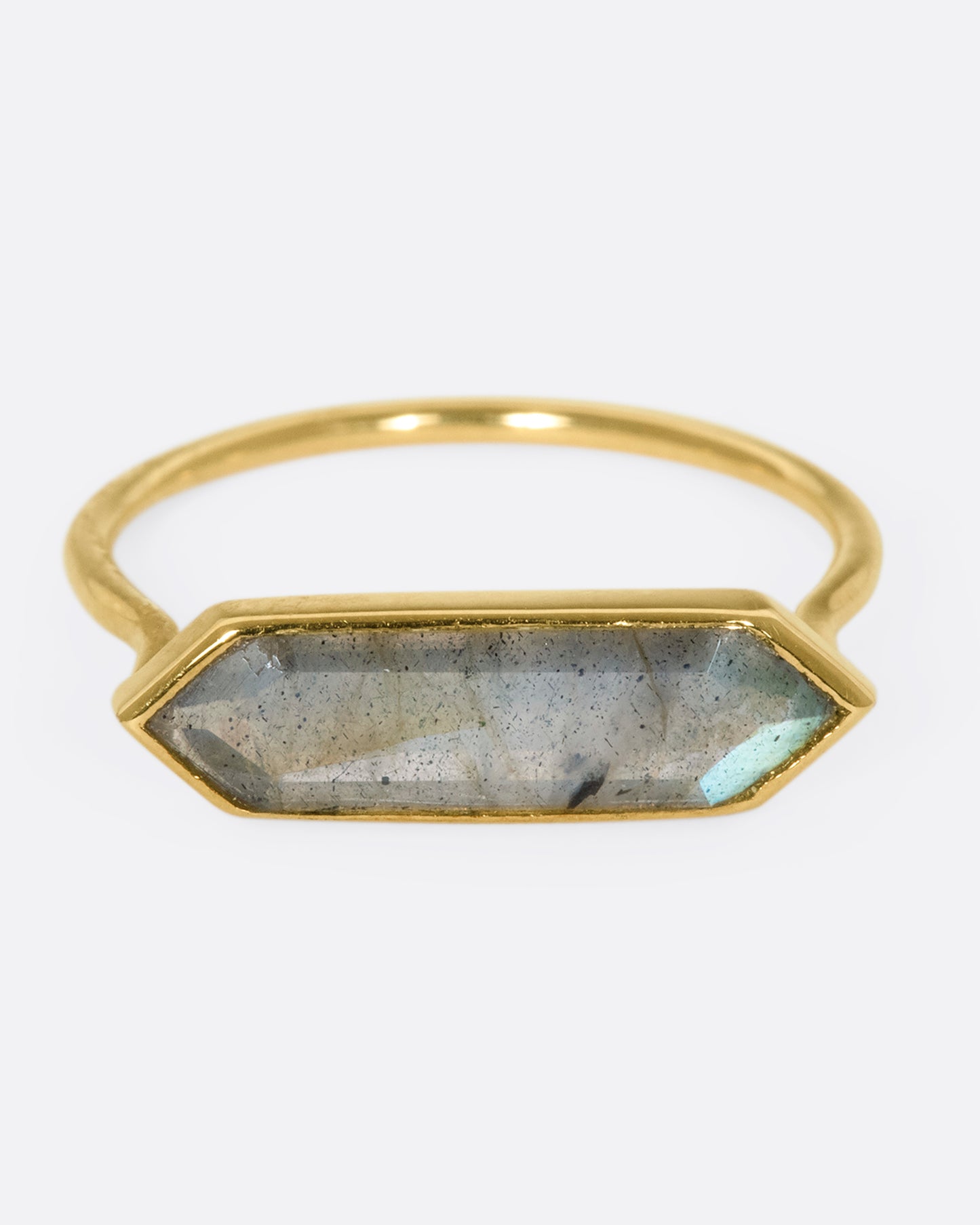 A yellow gold ring with a hexagonal labradorite bar, shown from the front.