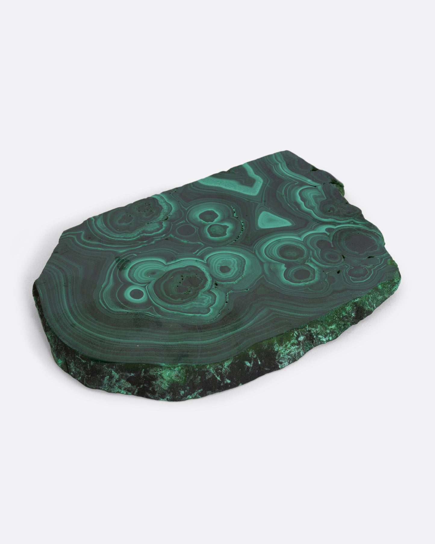 A slab of lush malachite shown lying flat.
