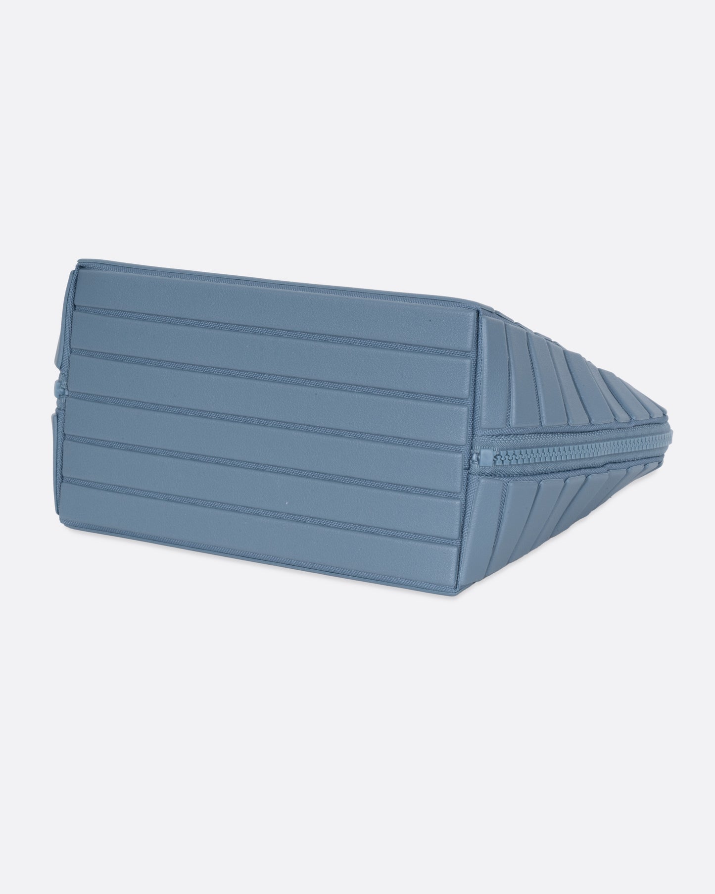 A blue textured rectangular pouch, shown from the bottom.