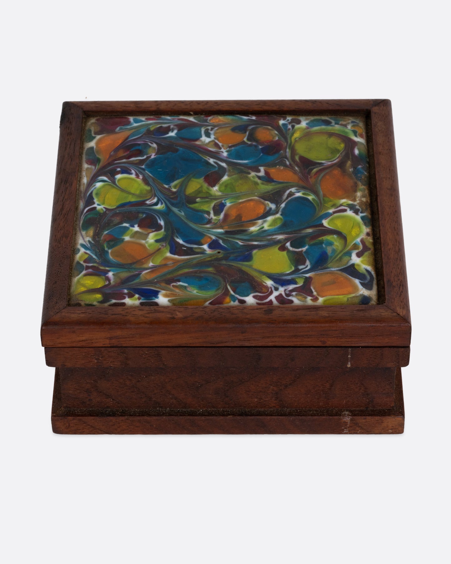 A wooden cigarette box with an abstract enamel design. Shown from the front.