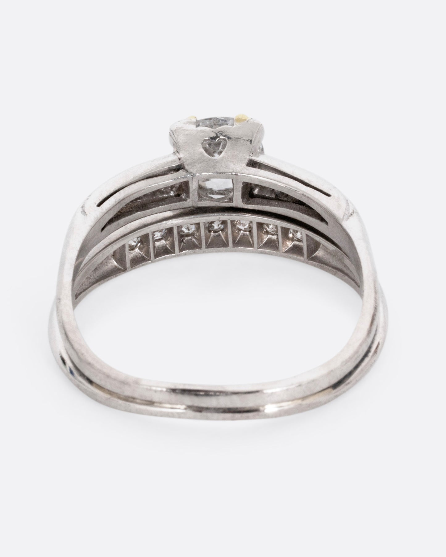 A platinum ring with an Old European cut diamond and a split shank, shown from the back.