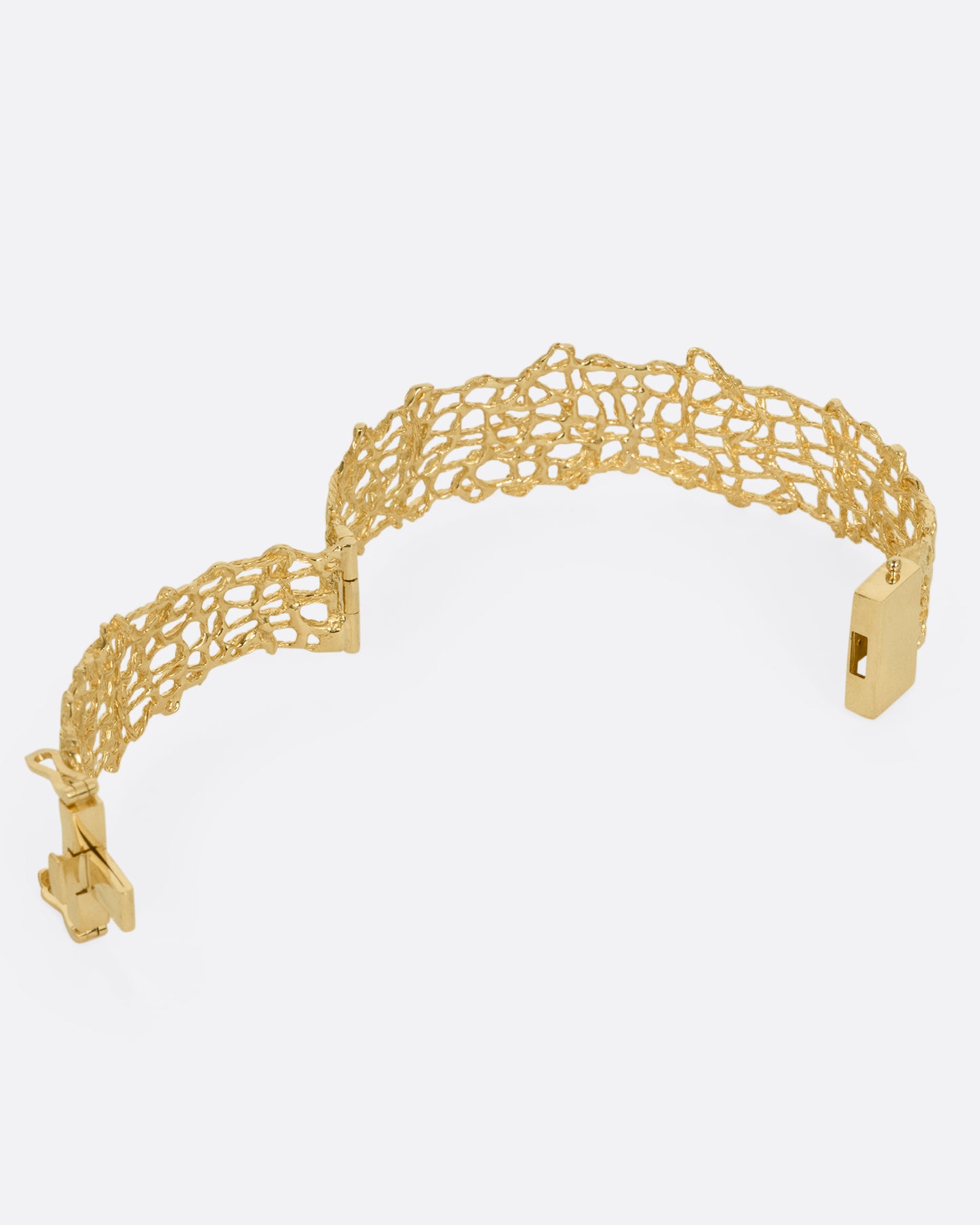 A woven yellow gold wire strand bracelet shown from the back open.