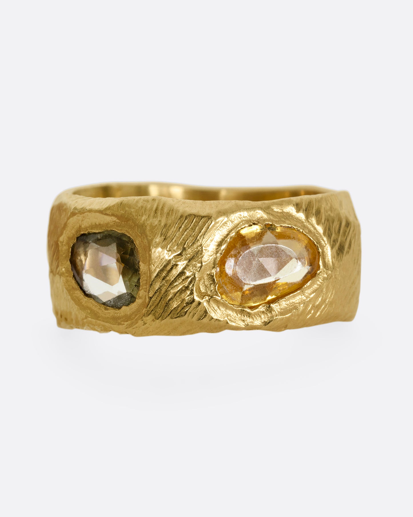 A yellow gold band with rose cut multicolor sapphires all the way around.