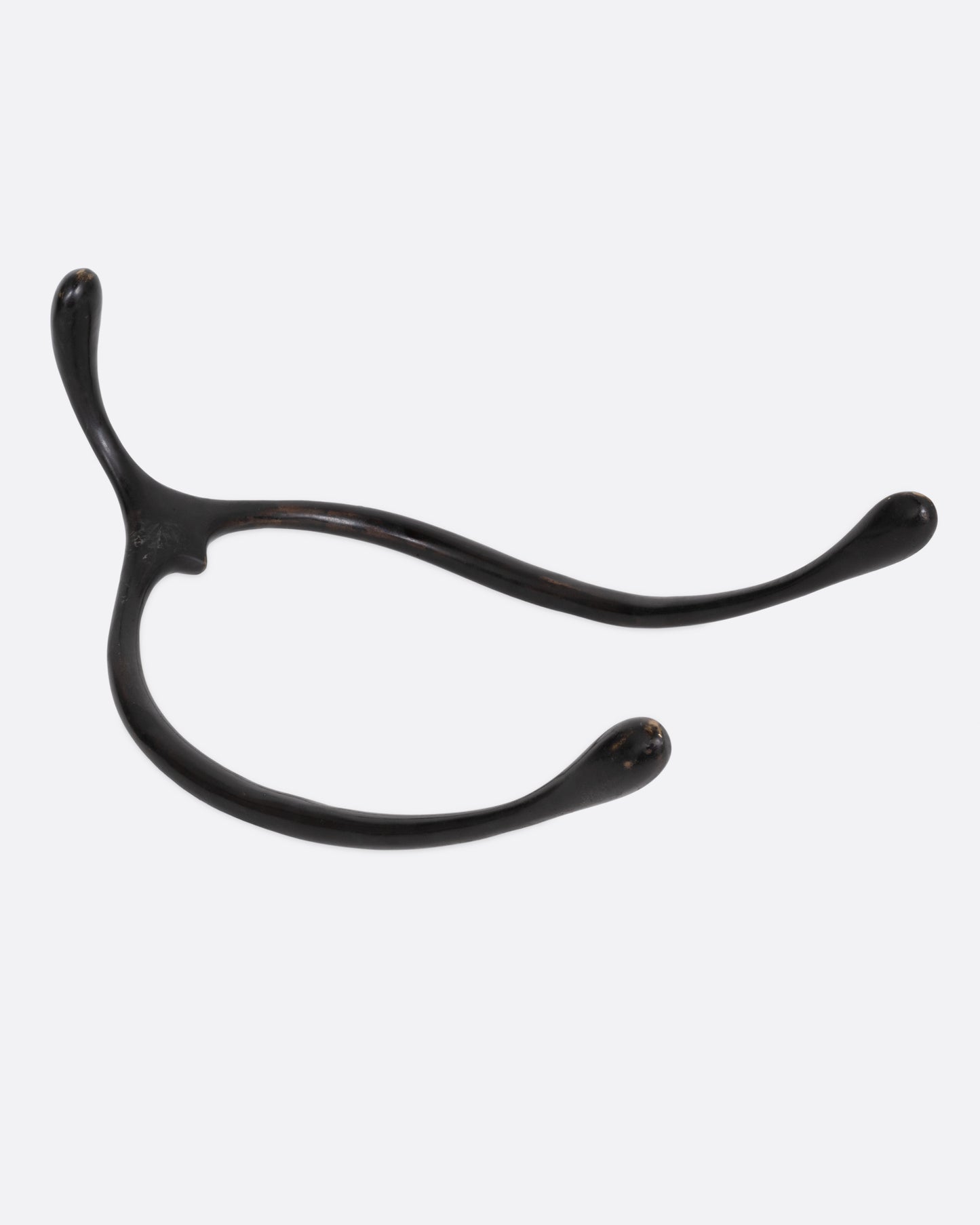 A black bronze wishbone sculpture, shown from the side.