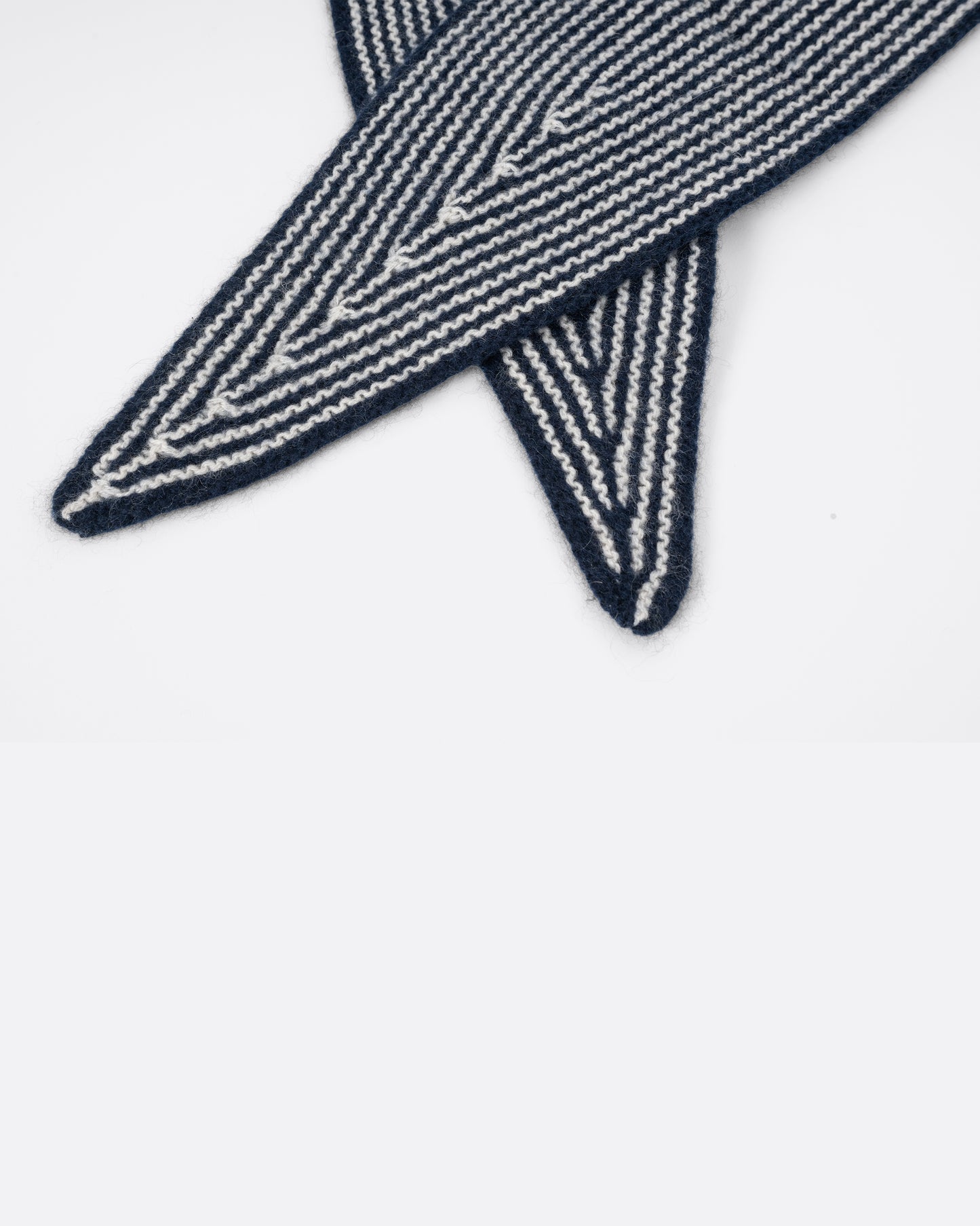 A navy striped cashmere scarf, shown close up.
