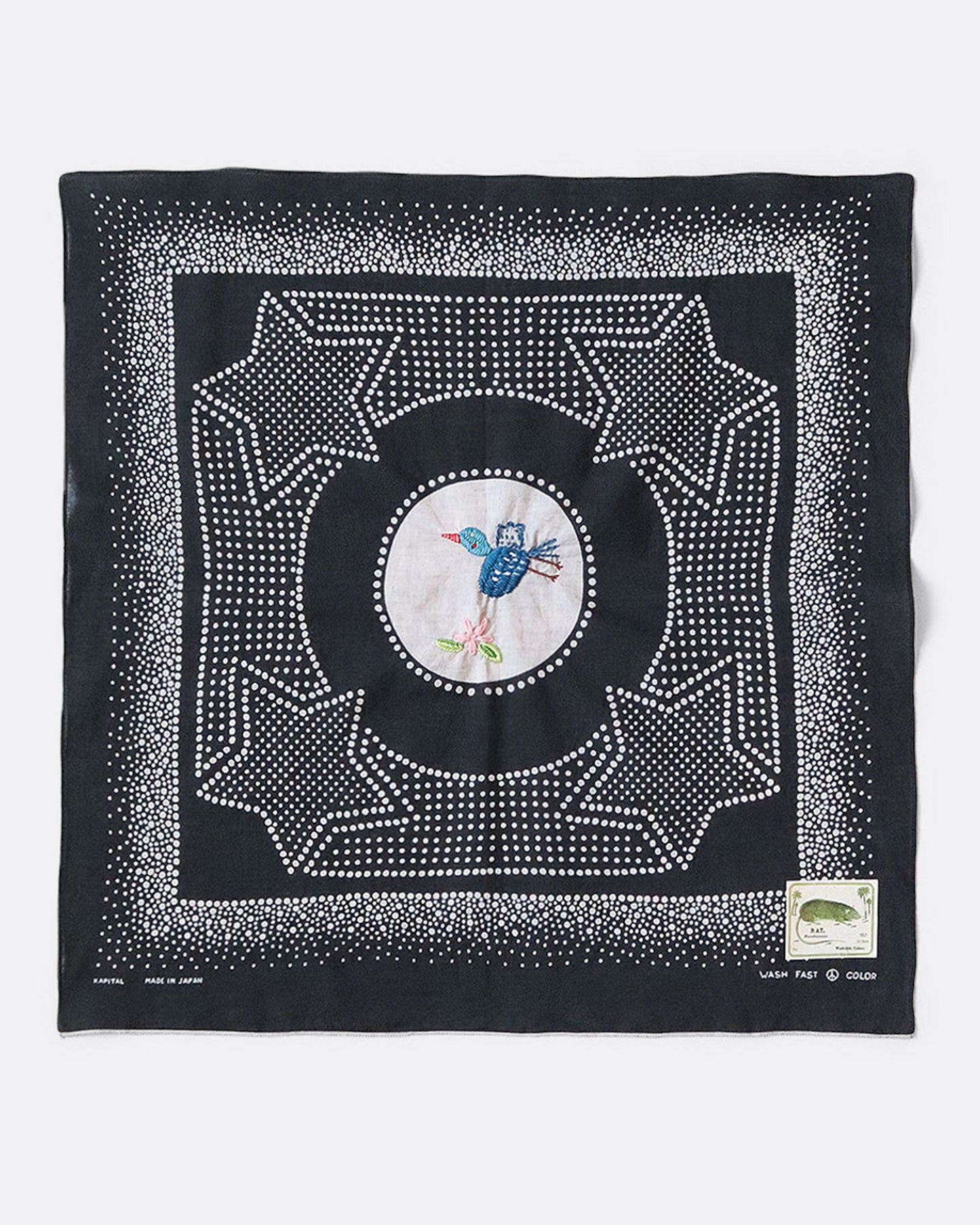 A black bandana with a spotted star motif and a hand- embroidered magpie at the center. Shown from the front.