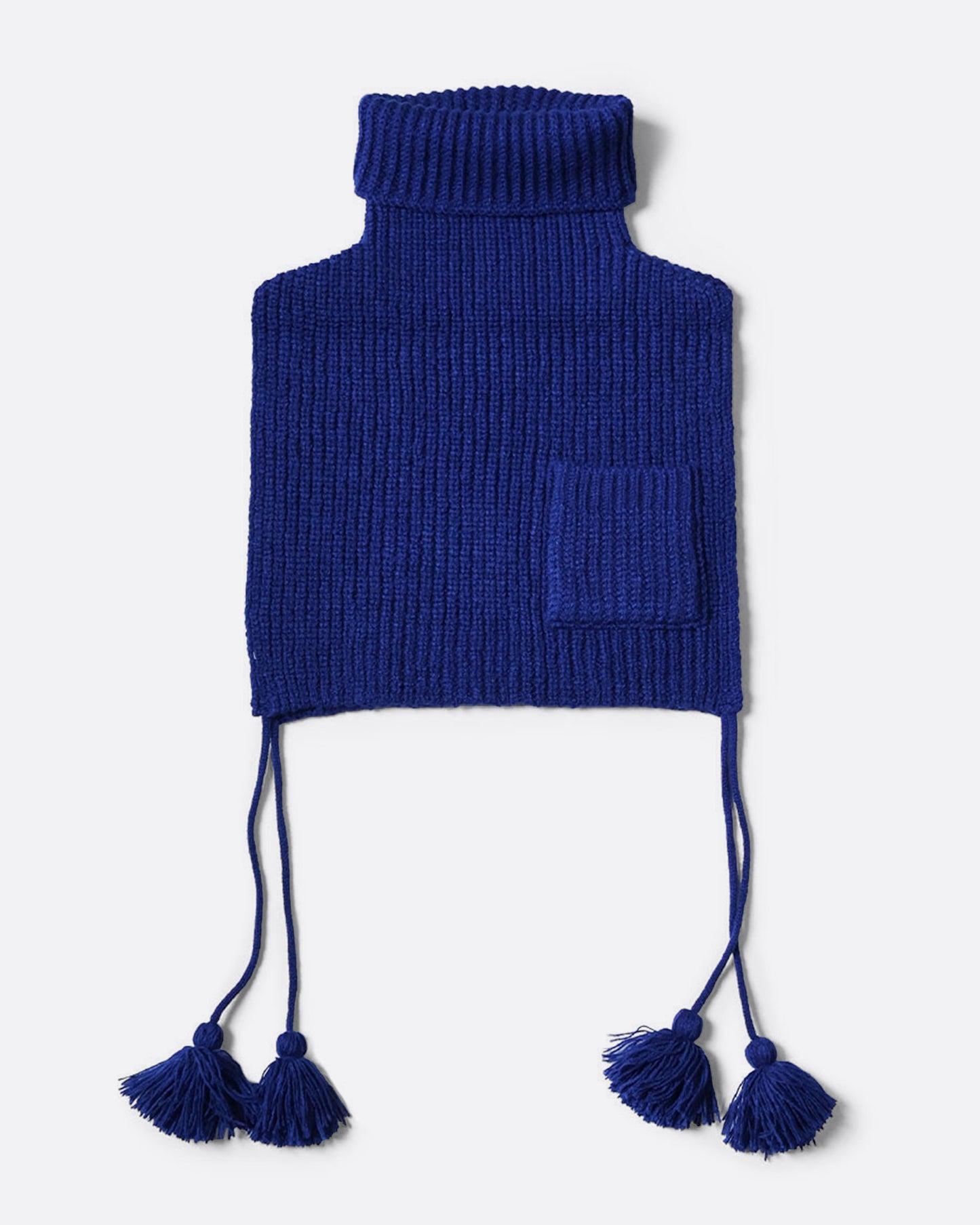 A blue loose knit bib poncho with a front pocket, long tassels, and a high neck, shown from the front.