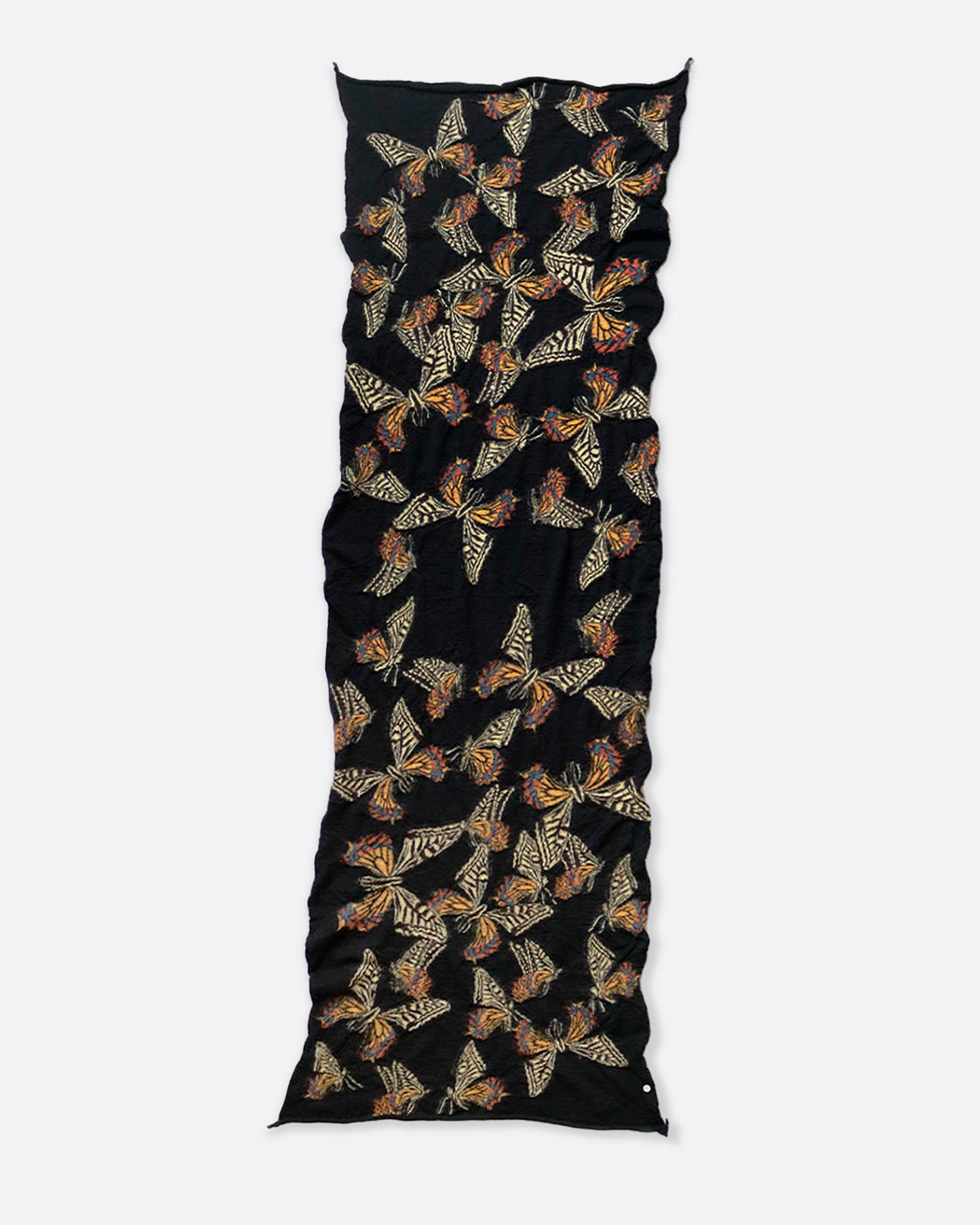 A black compressed wool scarf with butterflies all over it, shown lying flat.