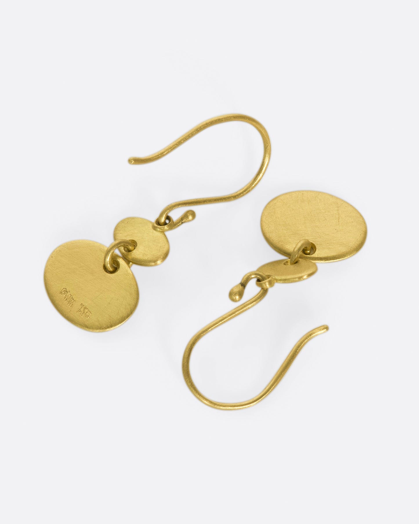 A pair of matte gold sequin earrings with great movement.