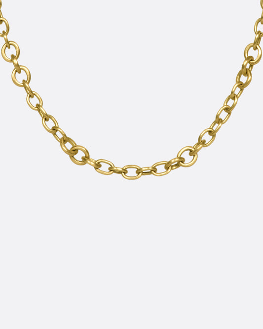 A beautiful 18K gold chain that will rest along your collar bone. Heavy enough to wear on its own in a neck mess and fine enough to add a pendant or two.