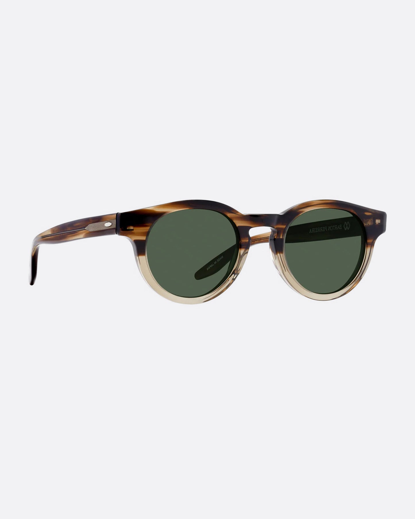 A round pair of sunglasses with frames that are brown on top and tan on the bottom. The lenses are dark green. Shown diagonally from the front.