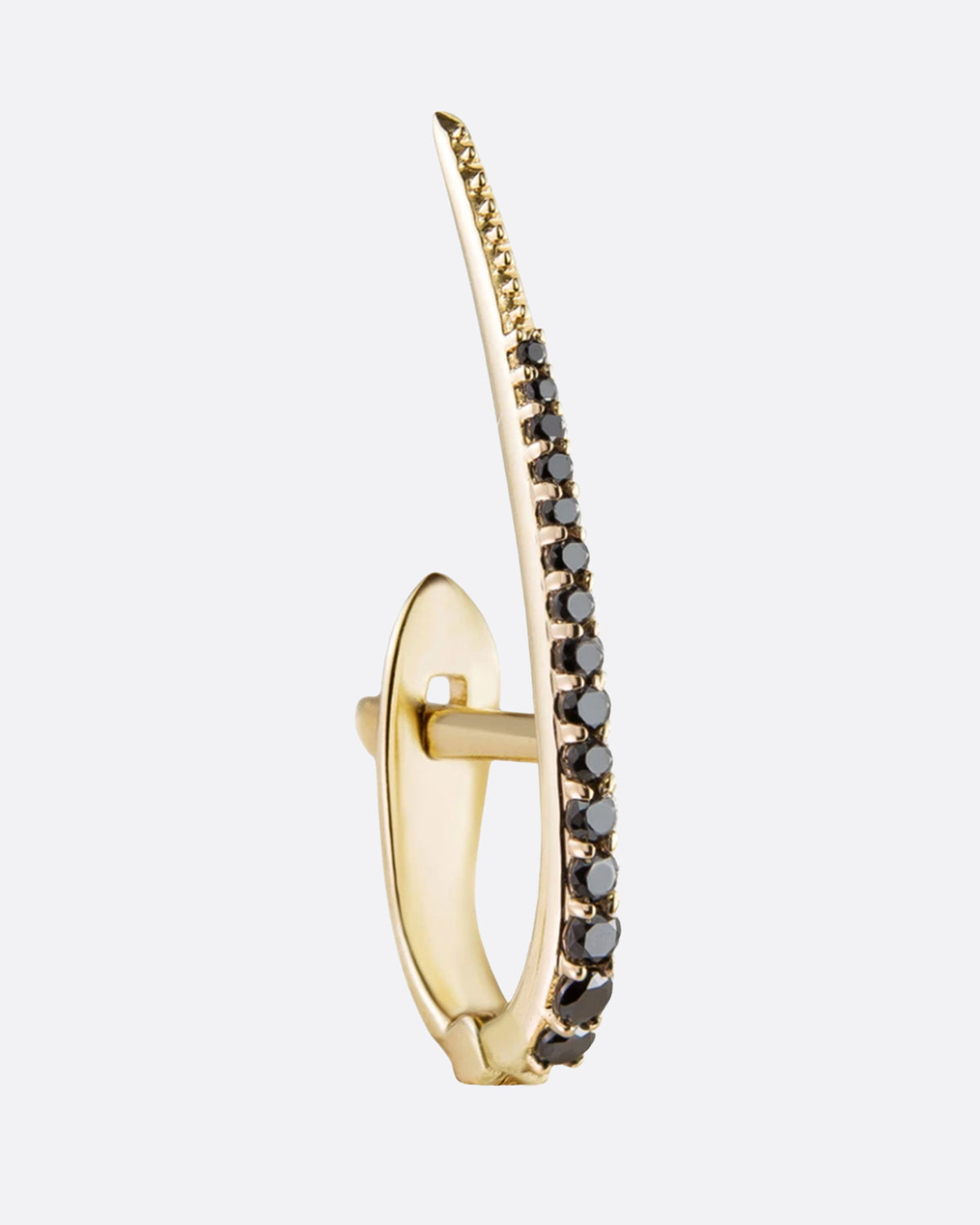 A yellow gold huggie hoop style earring with an elongated black diamond studded point. Shown from the front.