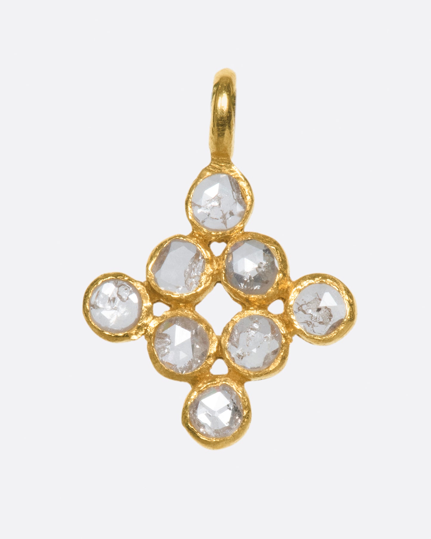 A yellow gold charm with eight rose cut diamonds set in a diamond shape. Shown from the front.