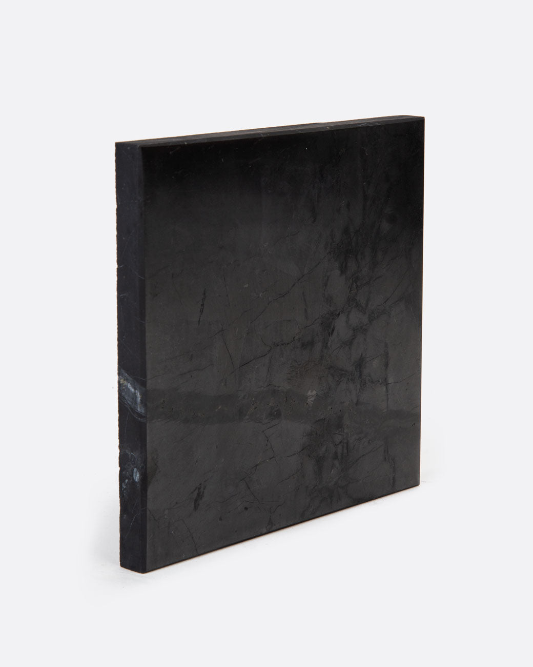A black stone tile shown standing up at an angle.