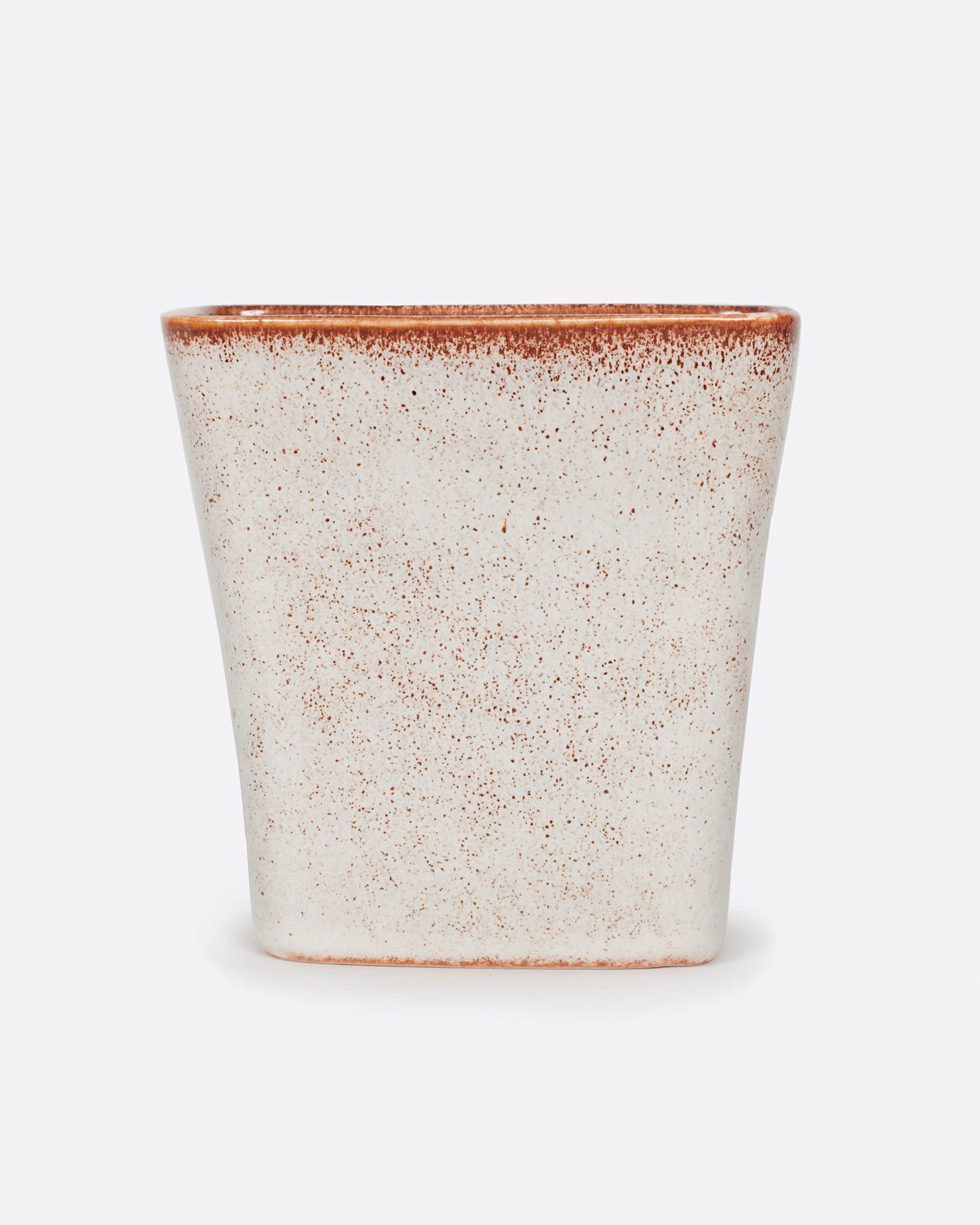 A warm white vase with brown speckles.