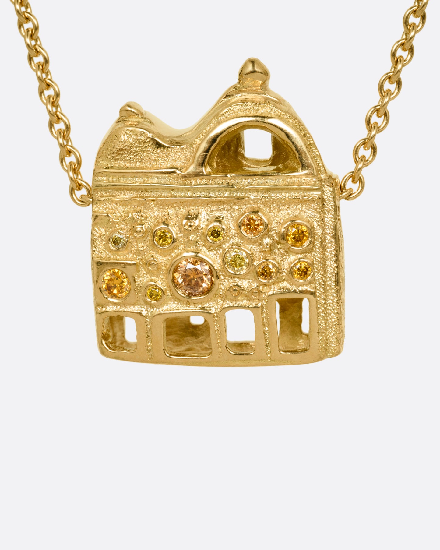 A yellow gold cable chain with a house shaped pendant with open windows and multicolored diamonds, shown from the back.