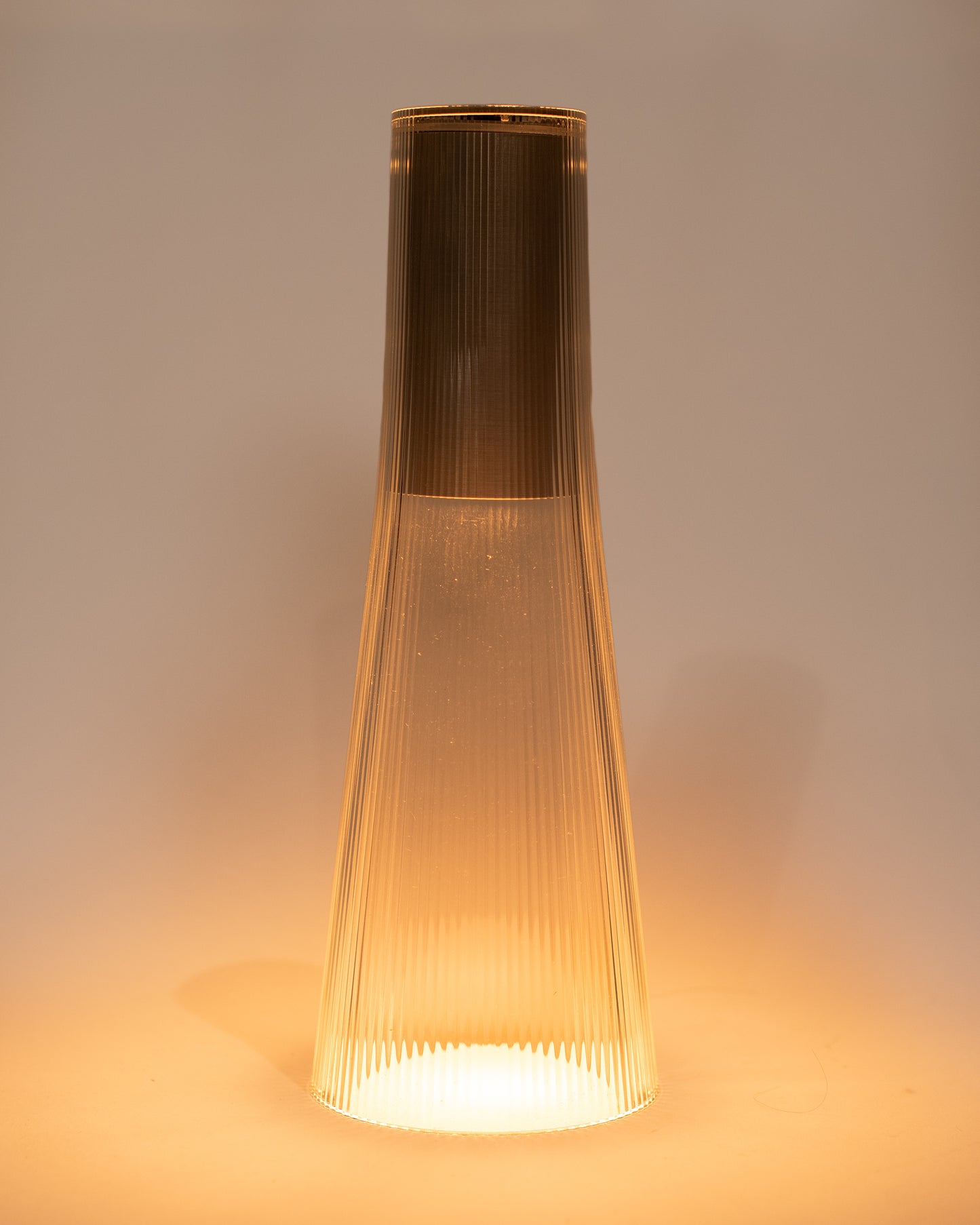 A rechargeable flared table lamp in a silver color way.