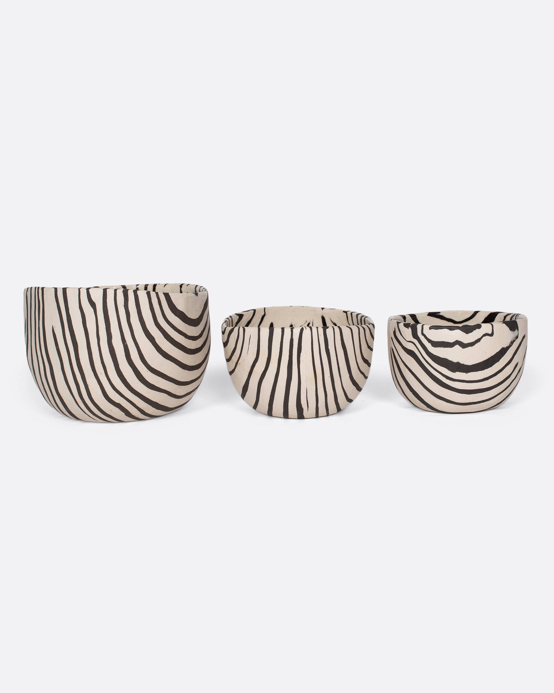 These small-batch ceramic bowls are made with a traditional Japanese Nerikomi technique that creates an intricate, marbled design by layering and compressing clay. Each bowl has a unique, zebra-striped design that feels other-worldly and timeless. Available in small, medium, and large sizes.